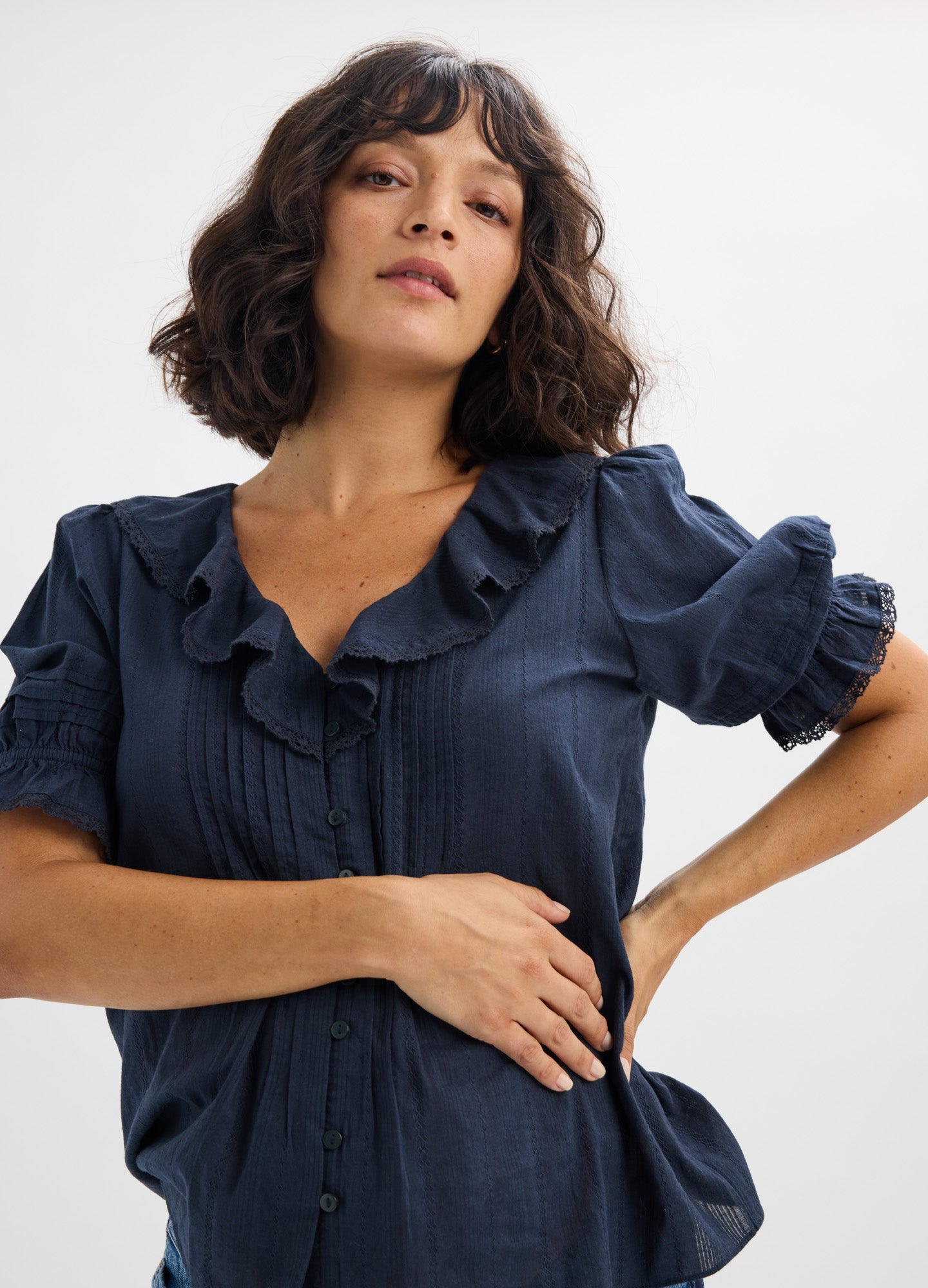 Navy blue nursing blouse with ruffled collar and short puff sleeves designed for maternity and pregnancy comfort.