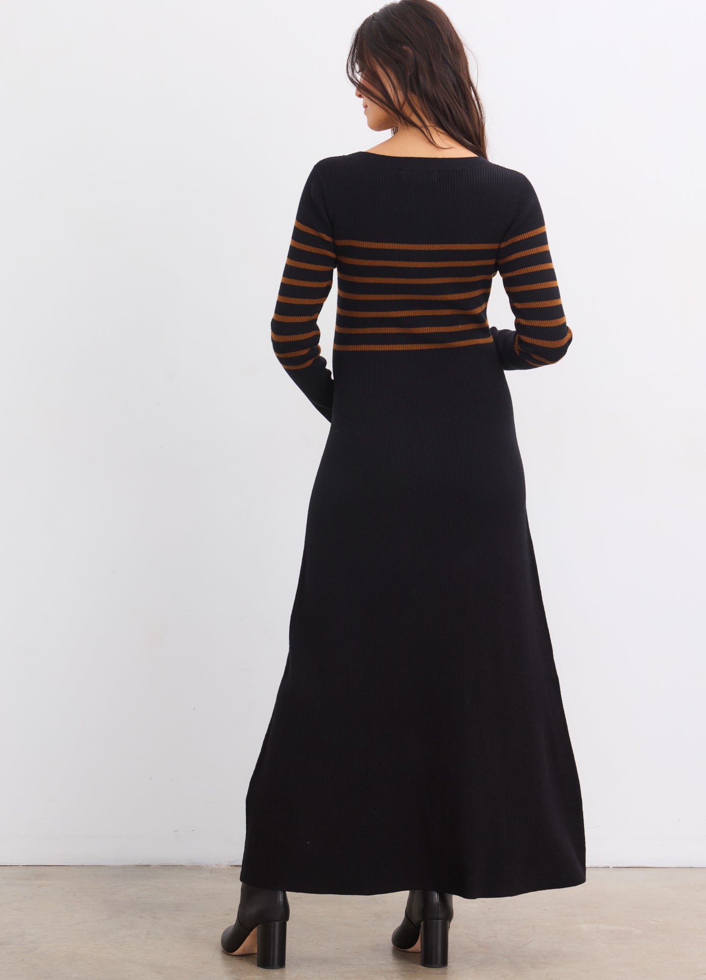 Black knit maternity sweater dress with brown horizontal stripes on upper bodice and sleeves, long sleeves, floor-length hem.