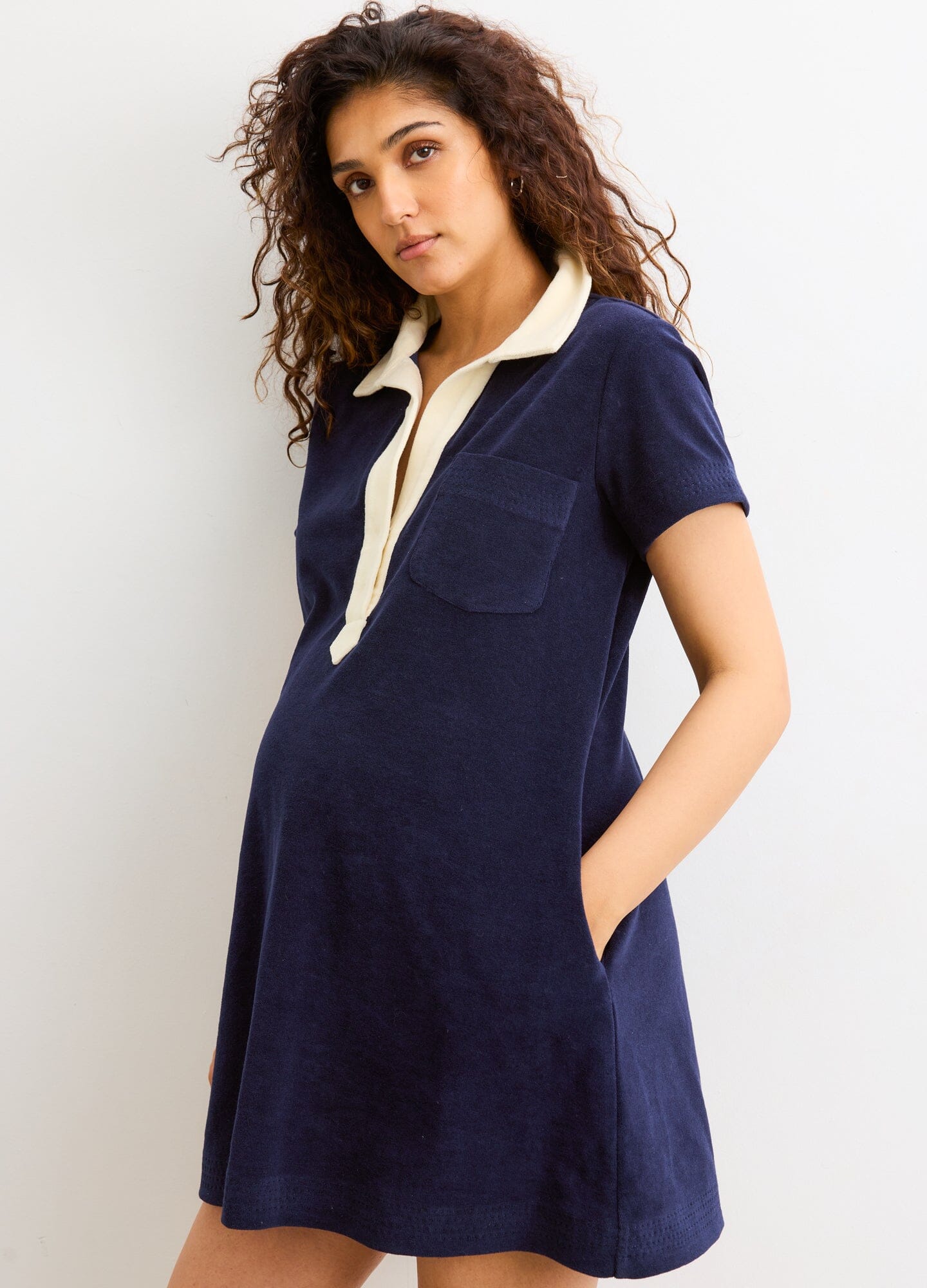 The Mitzi Dress - Navy maternity dress with short sleeves and beige collar, designed for pregnancy, nursing, and postpartum comfort.