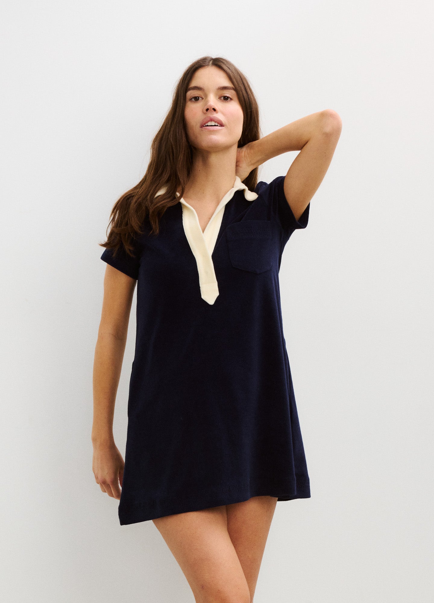 Navy maternity mini dress with short sleeves and white collar detail, relaxed fit.