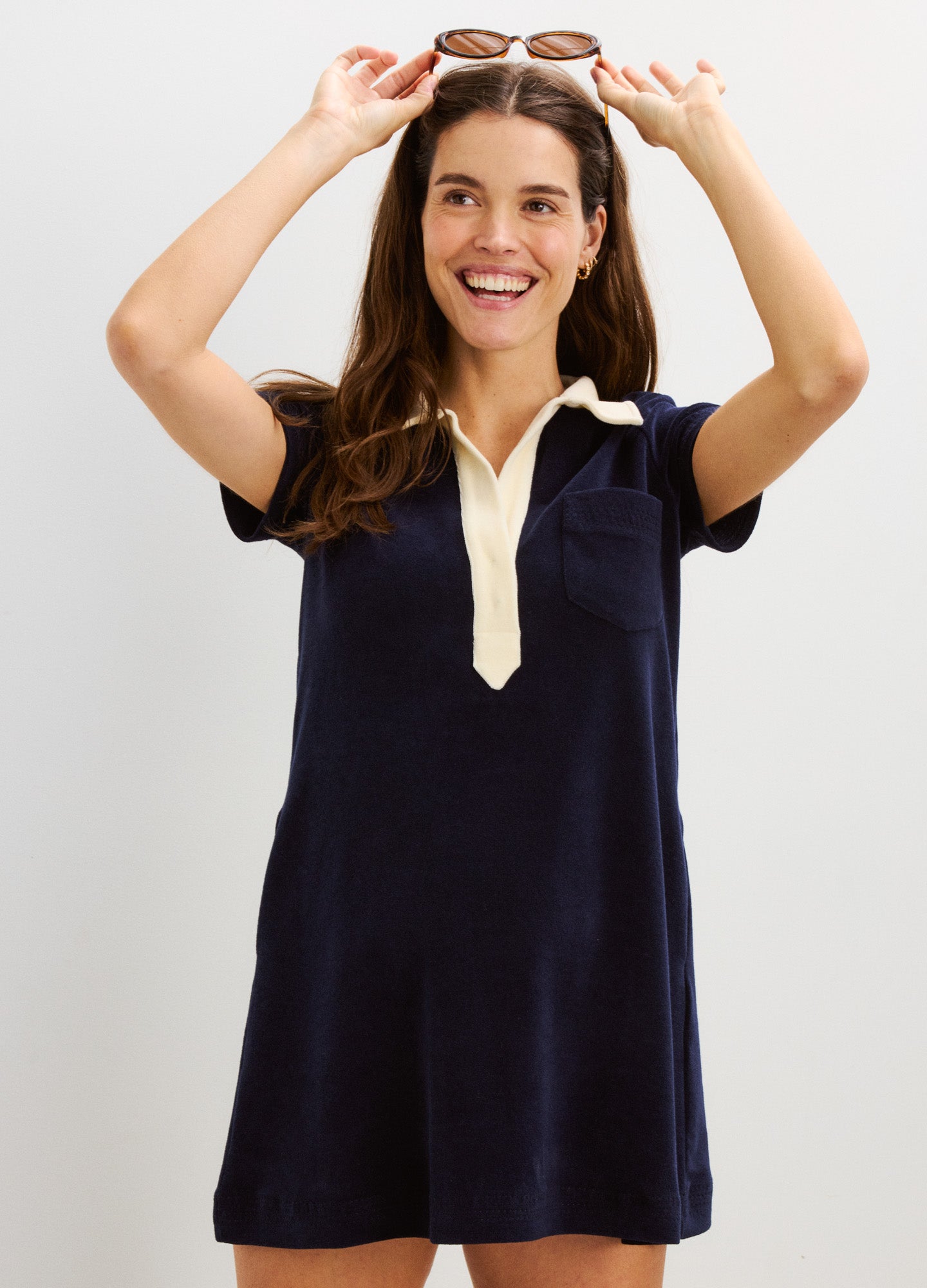 Navy blue maternity mini dress with white collar and short sleeves, relaxed fit for pregnant comfort.