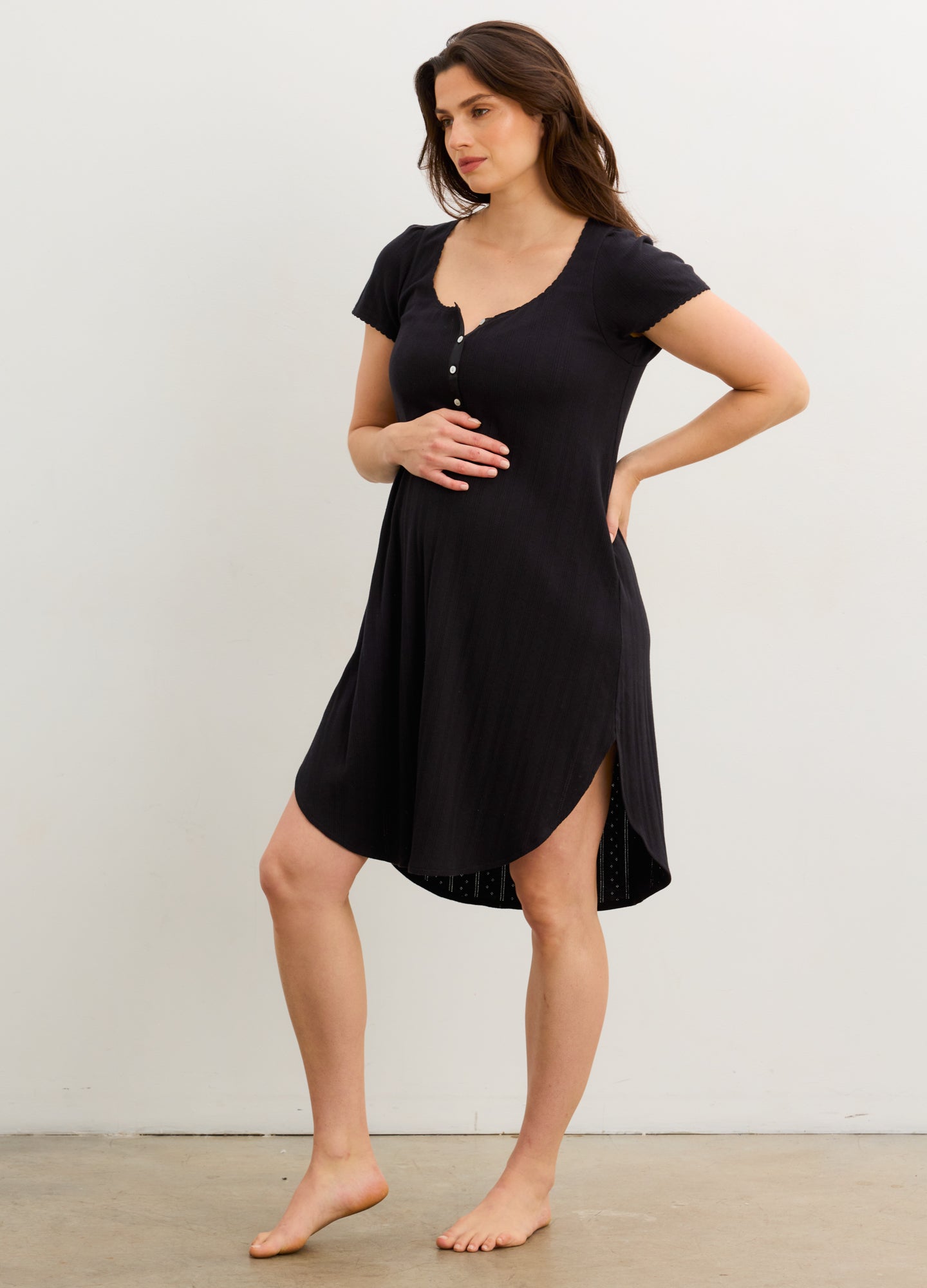 Black short-sleeve maternity nightgown with buttoned V-neck and scalloped hem.