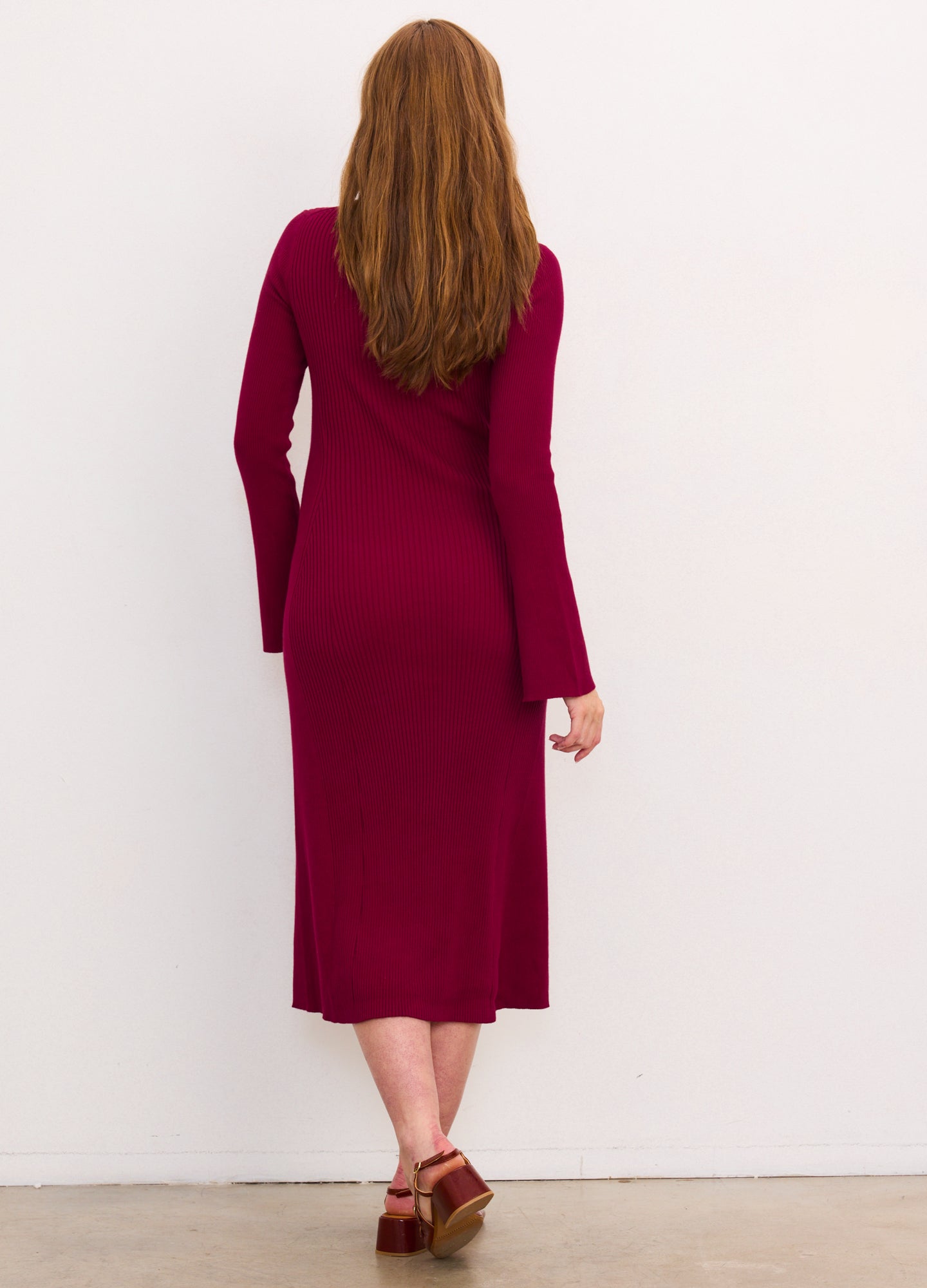 Burgundy ribbed midi dress with long sleeves, fitted silhouette, designed for maternity wear.