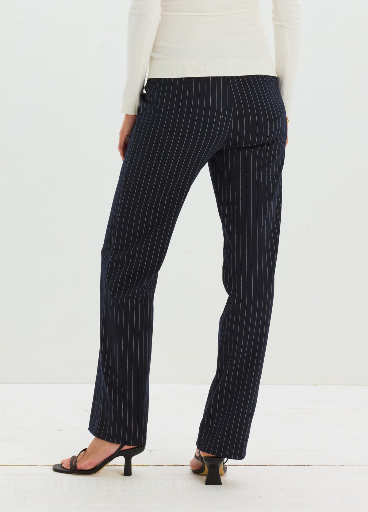 Black maternity work pants with white pinstripes, tailored fit, stretch fabric, full-length straight legs.