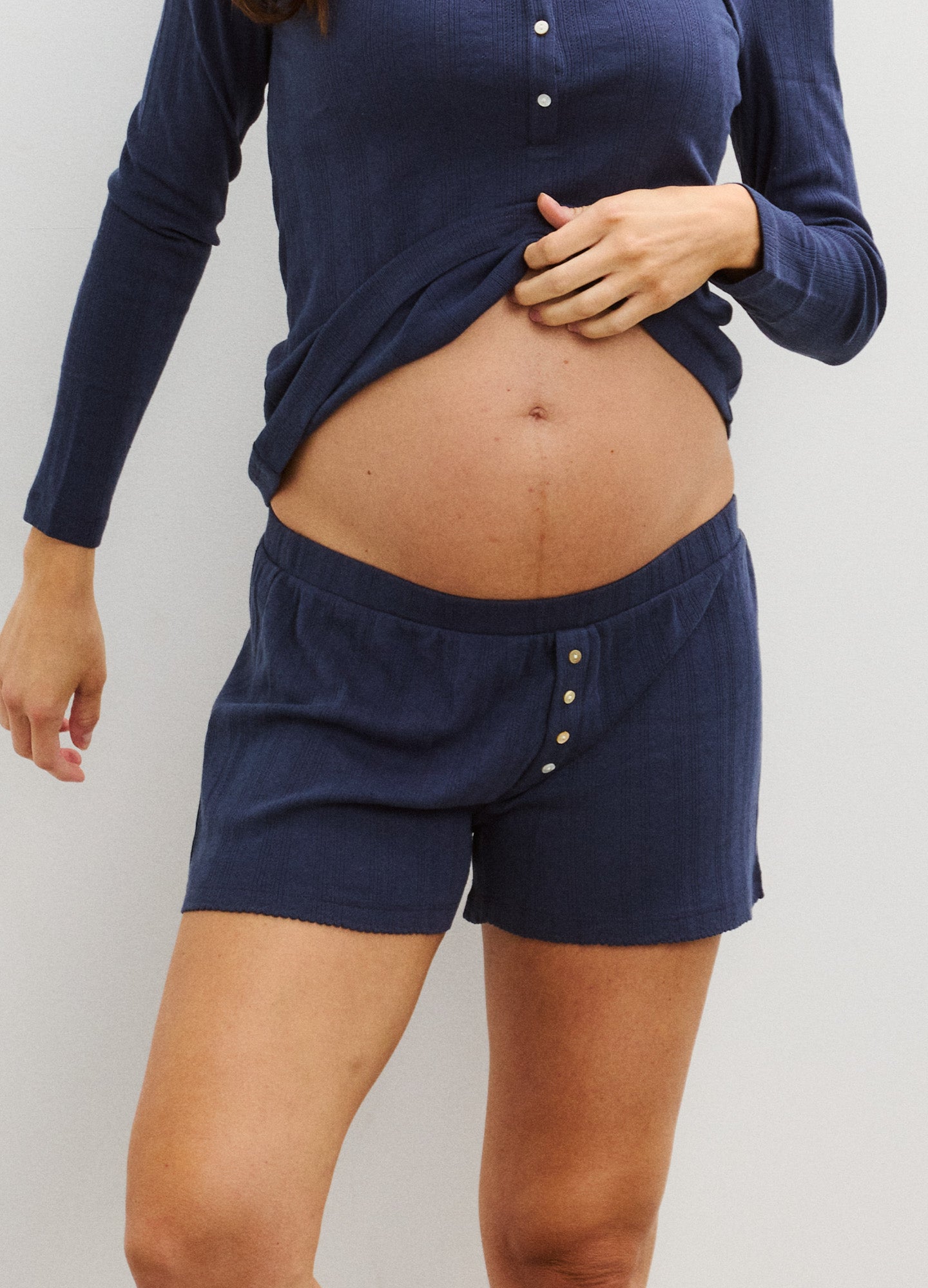 Navy blue soft knit maternity boxer shorts with button detail on front waistband.