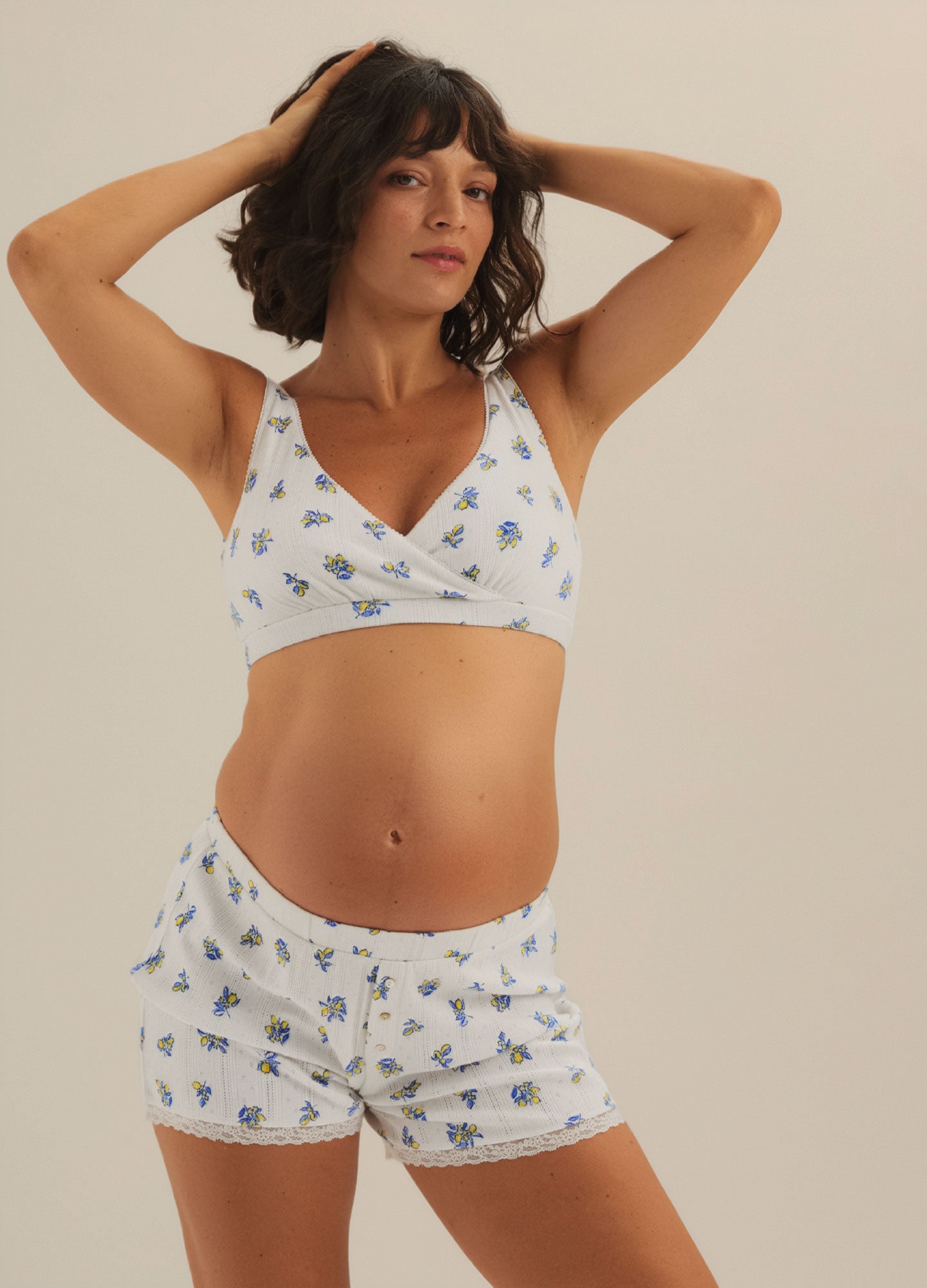 White soft knit maternity lounge shorts with small blue floral print and elastic waistband.