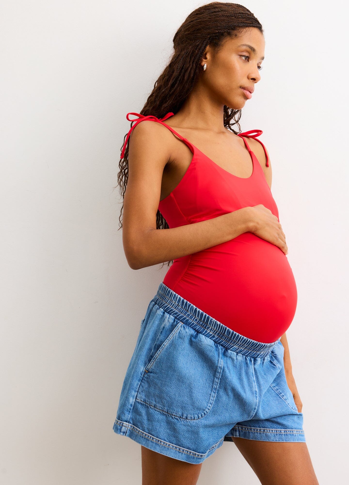 The Poppy One Piece - Red maternity one-piece swimsuit with adjustable shoulder ties, designed for pregnancy and nursing comfort.