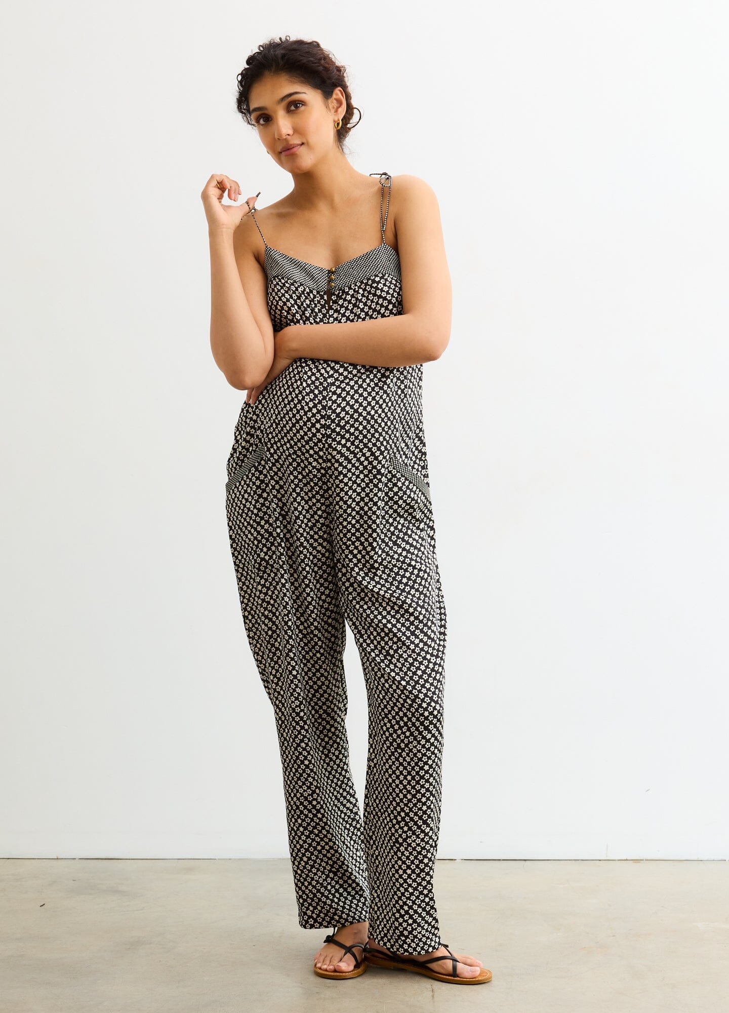 The Portia Jumpsuit - Black and white checkered maternity jumpsuit with adjustable straps and side ruching for pregnancy and nursing.