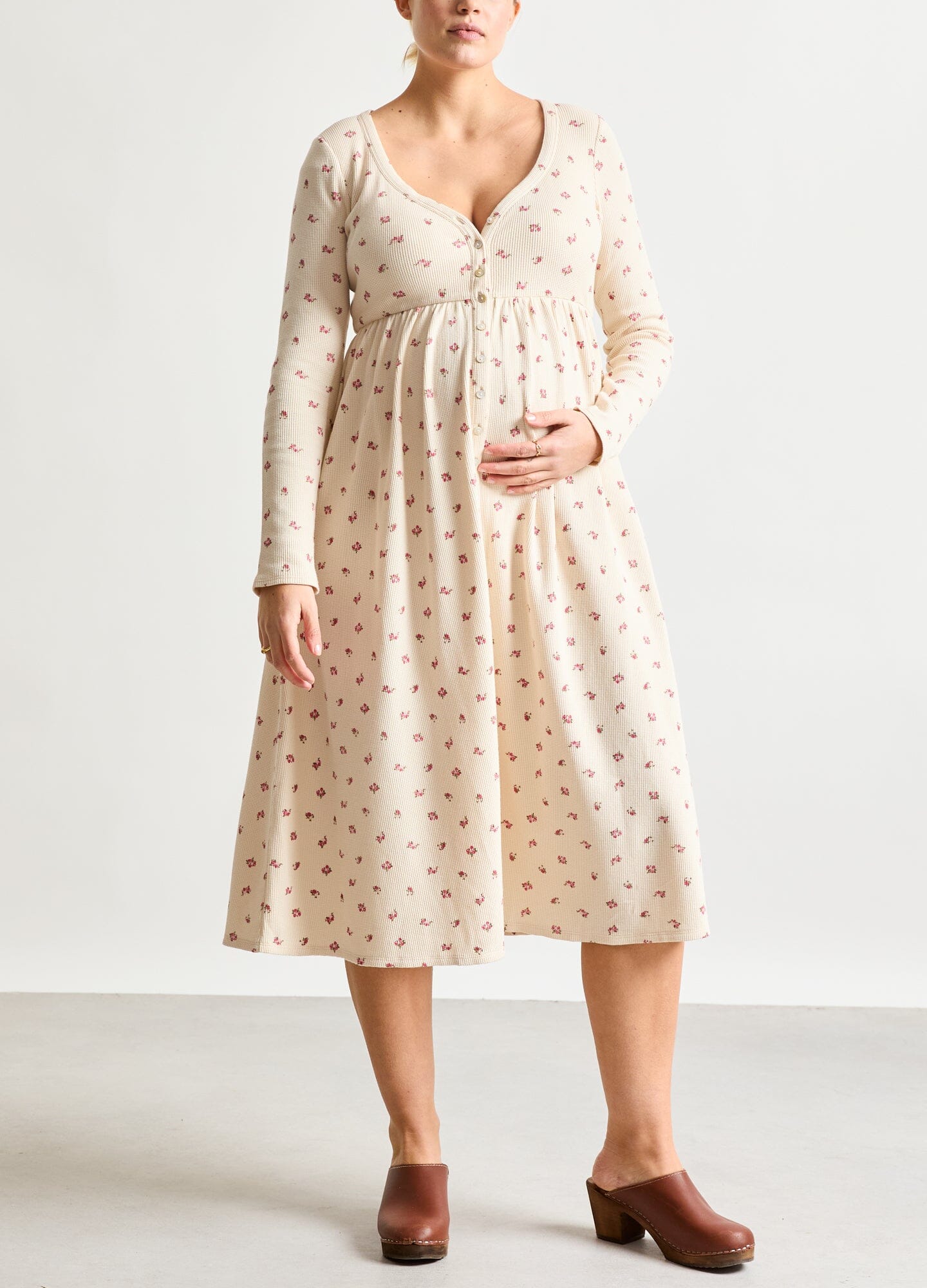 The Printed Waffle Nursing Dress - Cream waffle knit nursing dress with pink floral print, long sleeves, side slit, and V-neck, designed for maternity and.