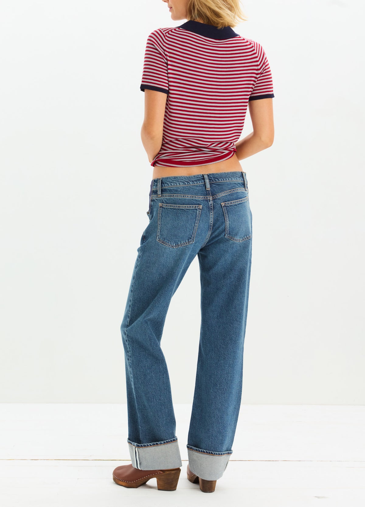 Blue denim maternity jeans with cuffed hems and a relaxed fit, designed to accommodate a pregnant belly.