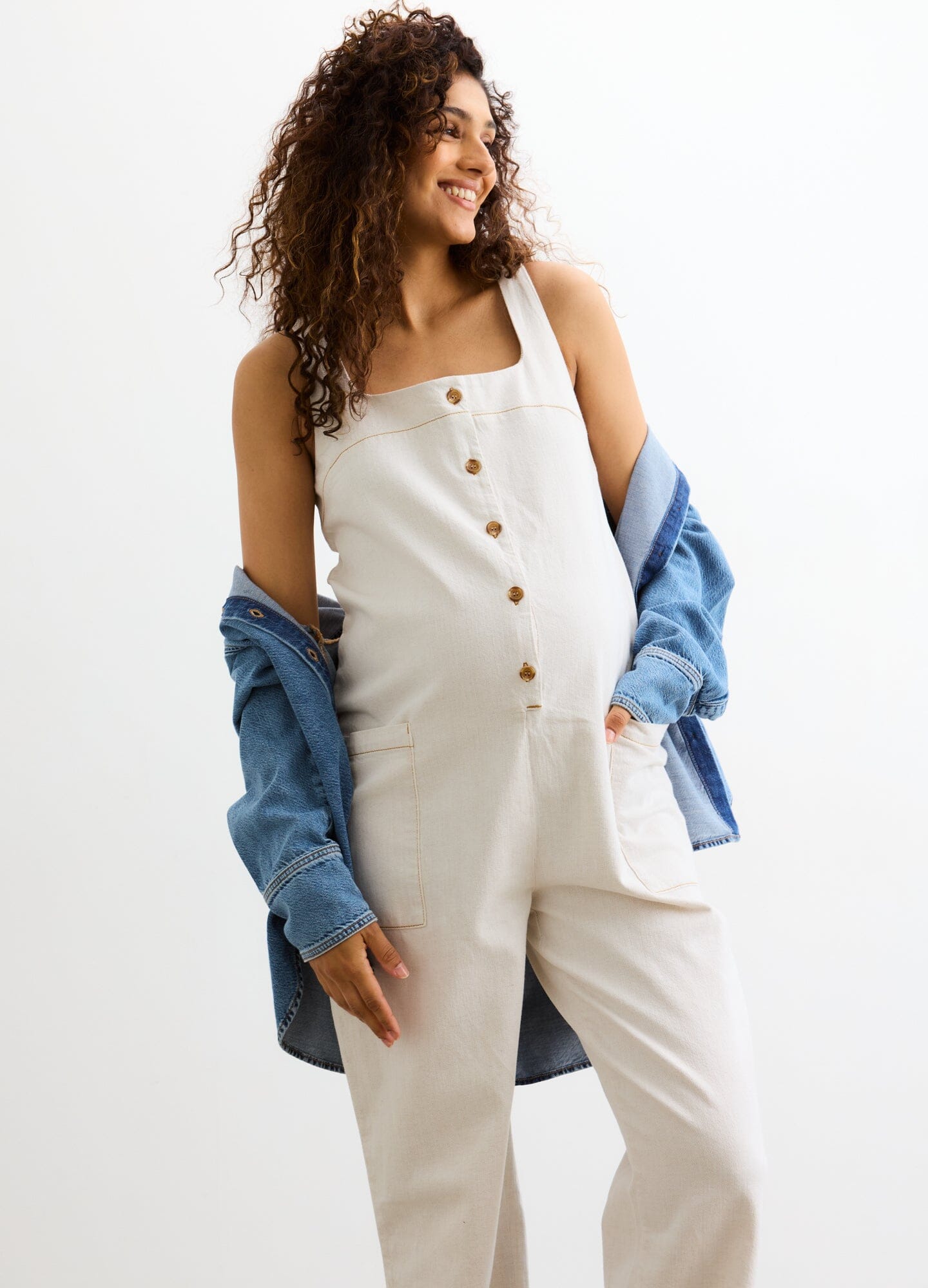 The Ryland Jumper - Chalk-colored maternity jumper with front buttons and wide straps, styled for nursing and postpartum comfort.