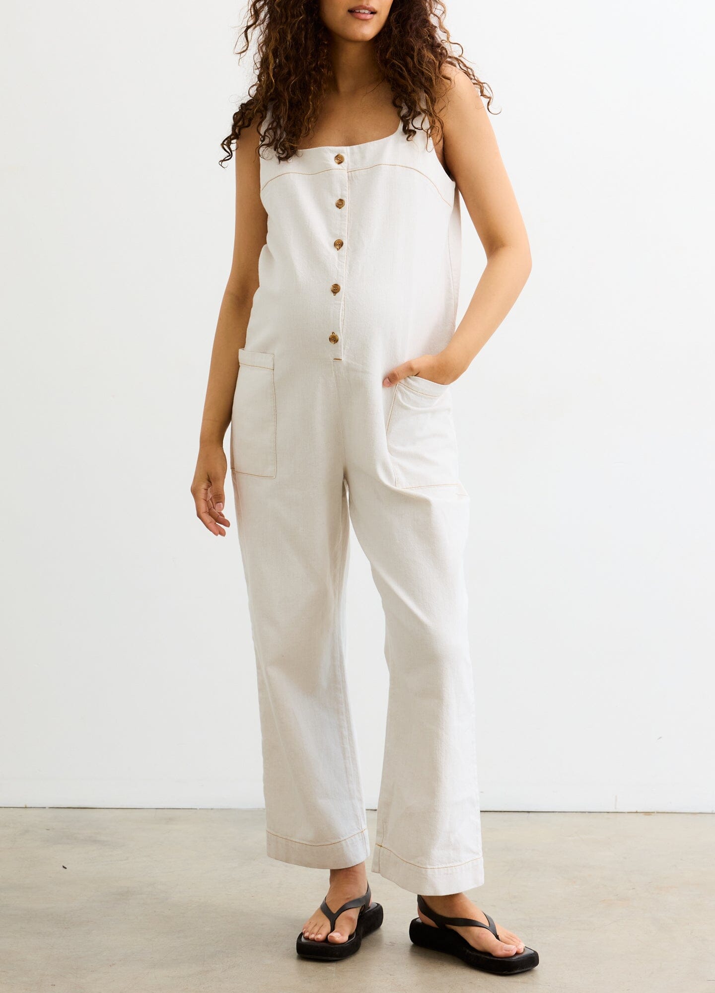 The Ryland Jumper - Chalk-colored maternity jumper with front buttons and wide straps, styled for nursing and postpartum comfort.