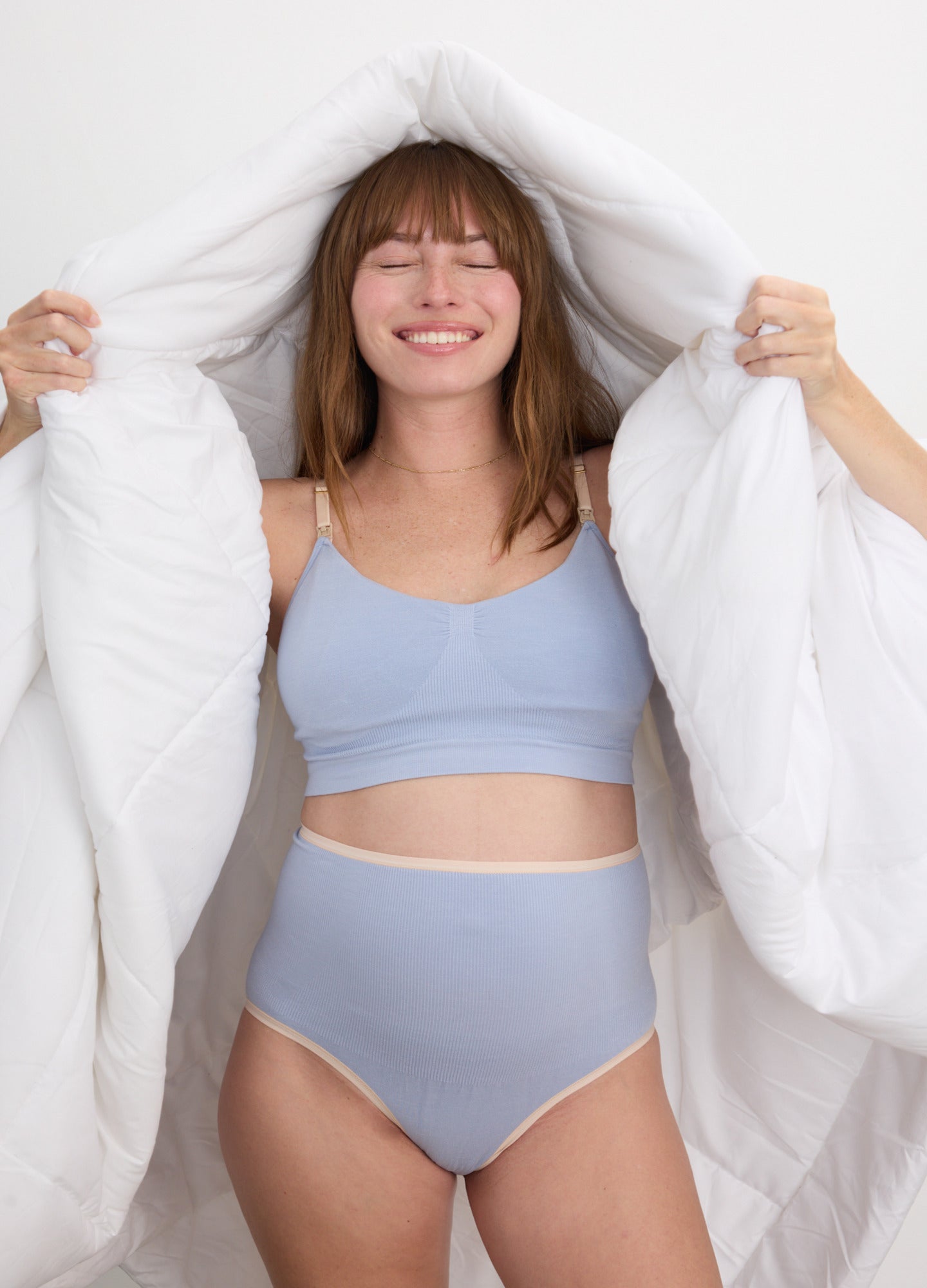 High-waist seamless maternity briefs in soft lavender blue with a smooth, stretchy fabric and full belly coverage.