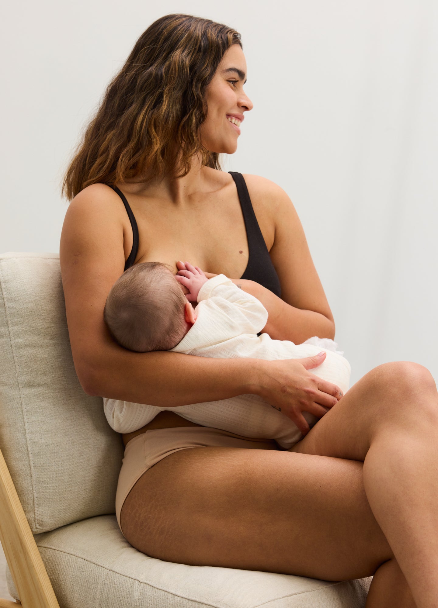 Black maternity bra with smooth fabric and adjustable straps, designed for nursing comfort.