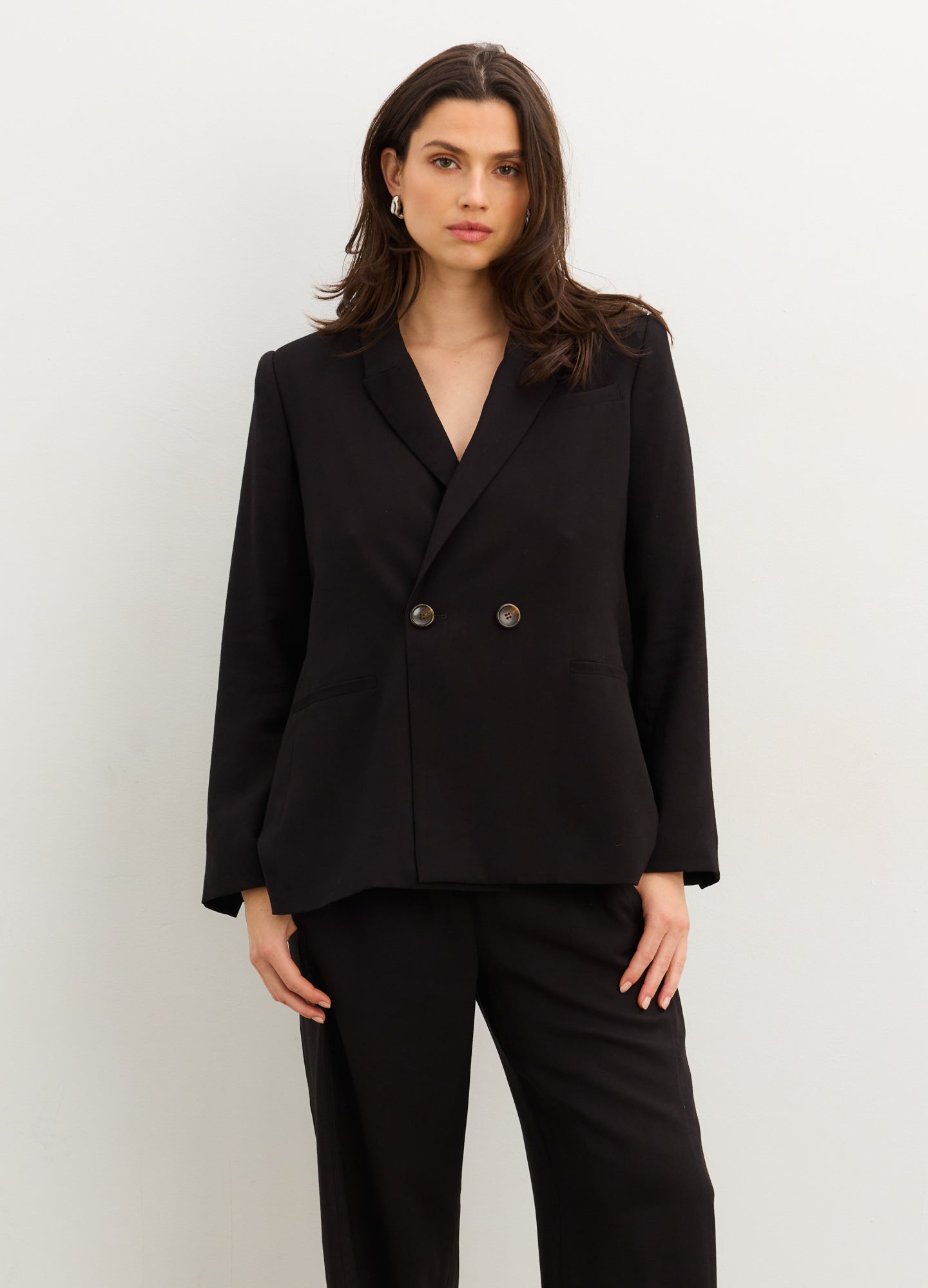 The Soft Tailored Twill Blazer - Black tailored twill blazer with double-button closure, designed for maternity, nursing, and postpartum wear.