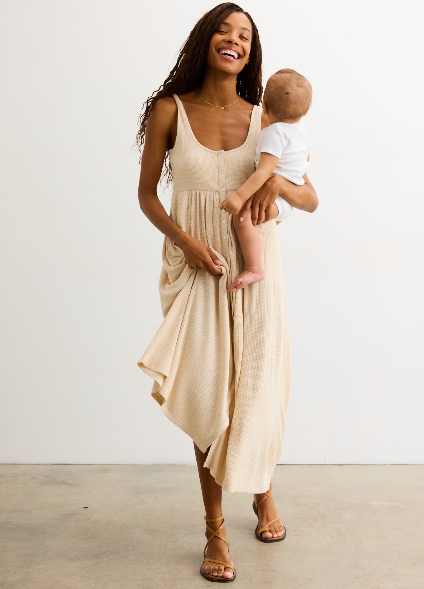 The Silky Ribbed Pointelle Nursing Dress - Sand-colored sleeveless midi dress with ribbed pointelle texture, designed for maternity, nursing, and postpartum.