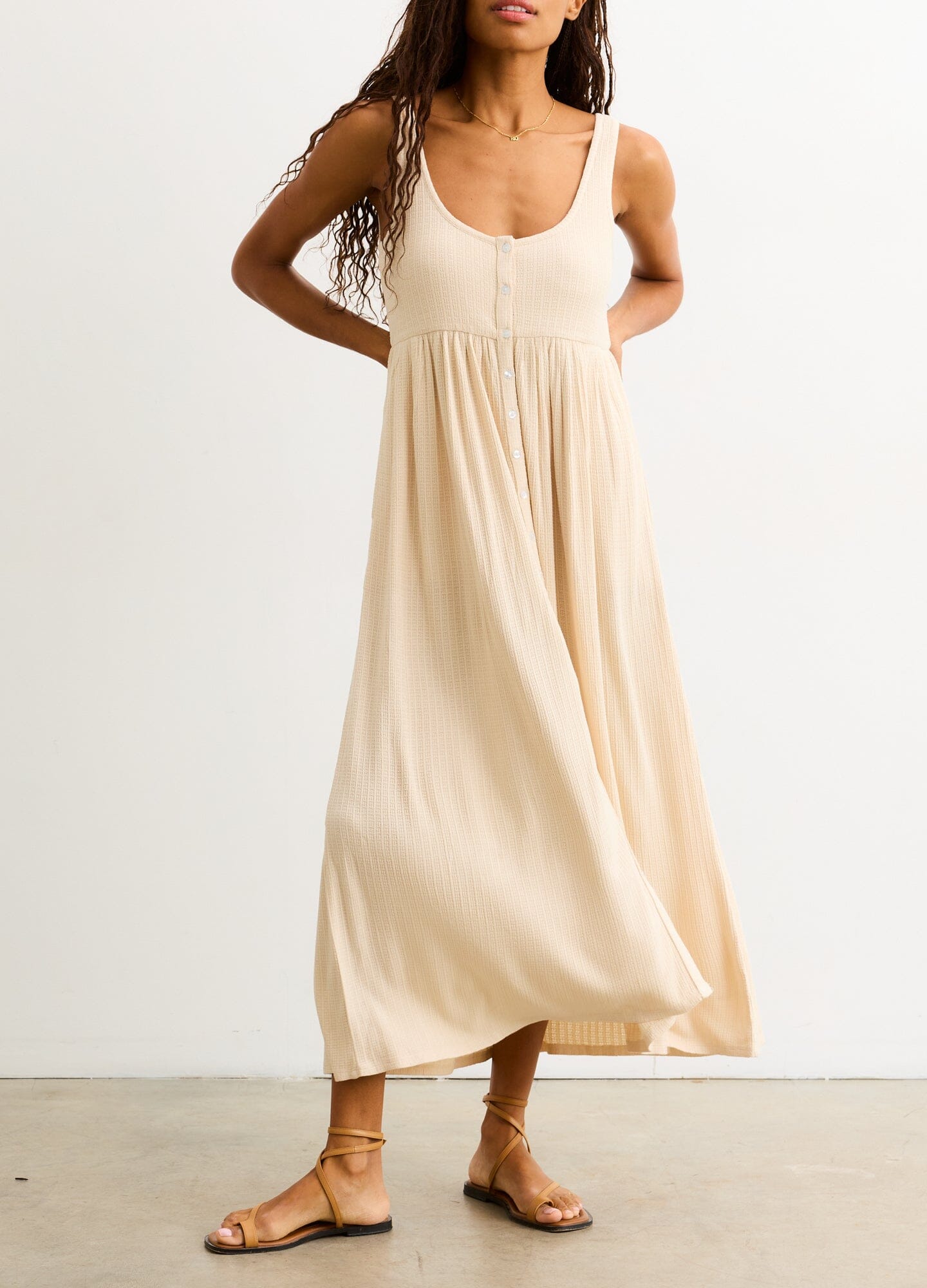 The Silky Ribbed Pointelle Nursing Dress - Sand-colored sleeveless midi dress with ribbed pointelle texture, designed for maternity, nursing, and postpartum.