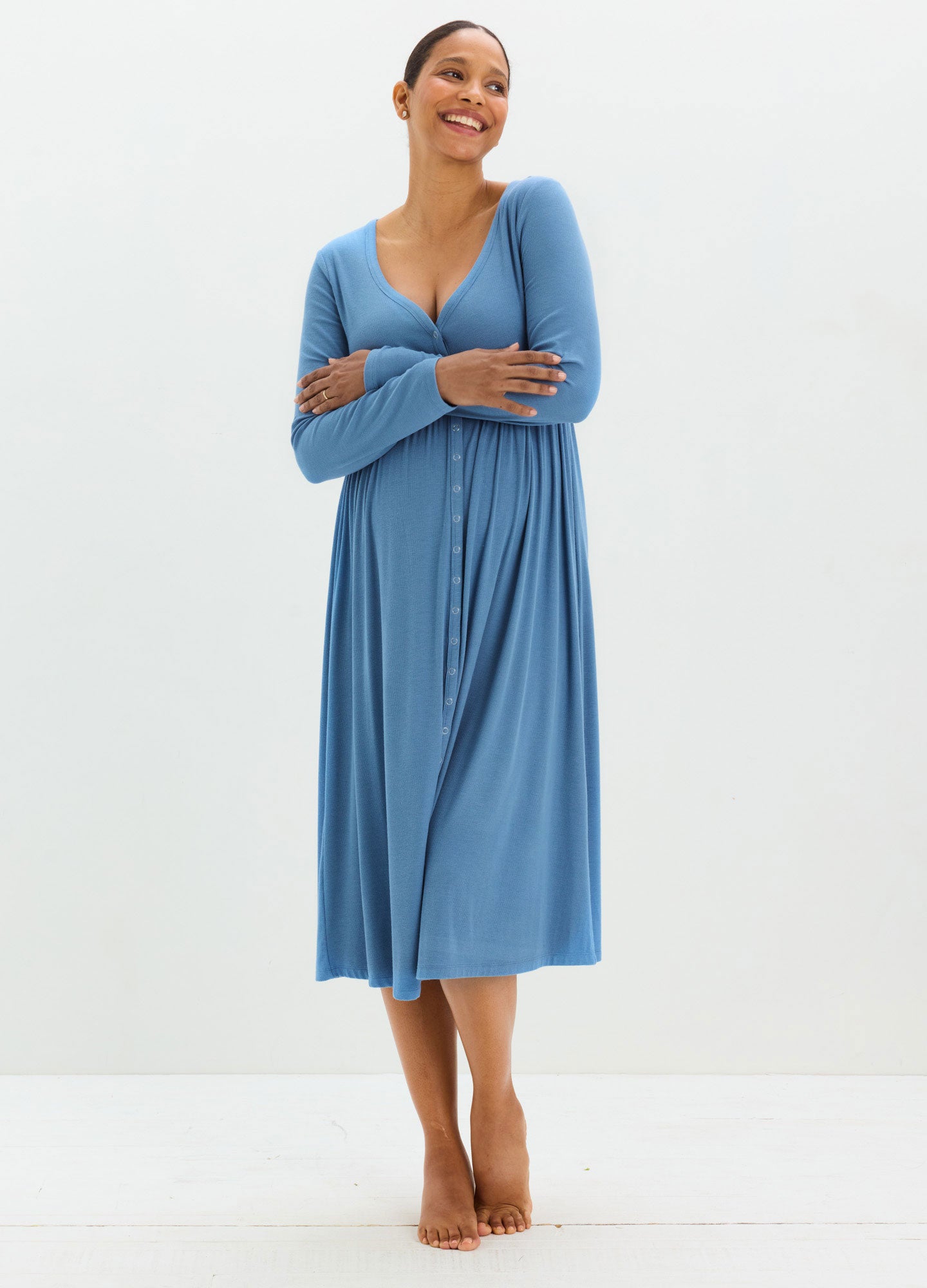 Light blue ribbed maternity dress with long sleeves, V-neck, and midi length designed for nursing.
