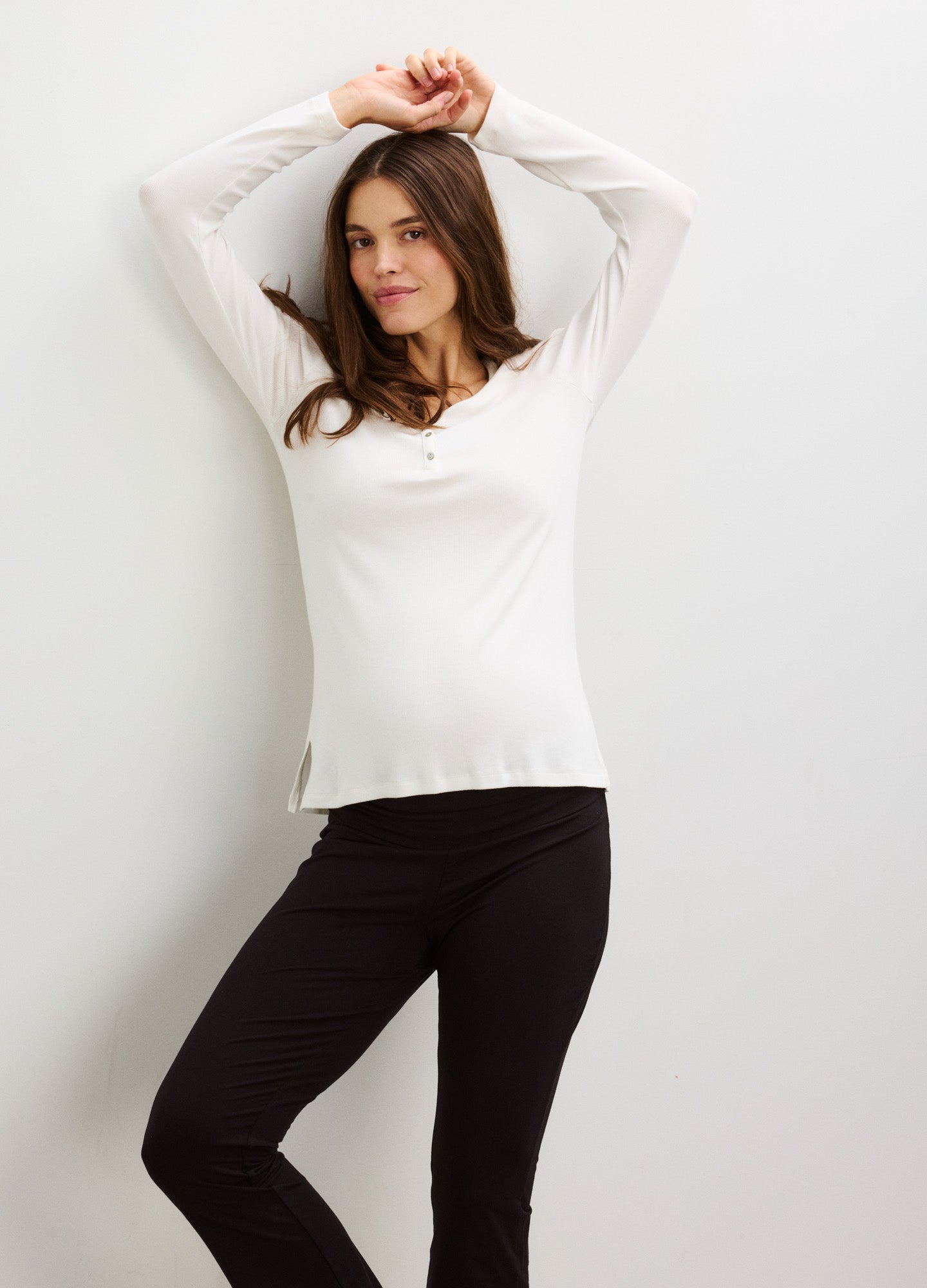 Cream-colored ribbed Henley top with long sleeves and button placket, fitted for maternity wear.