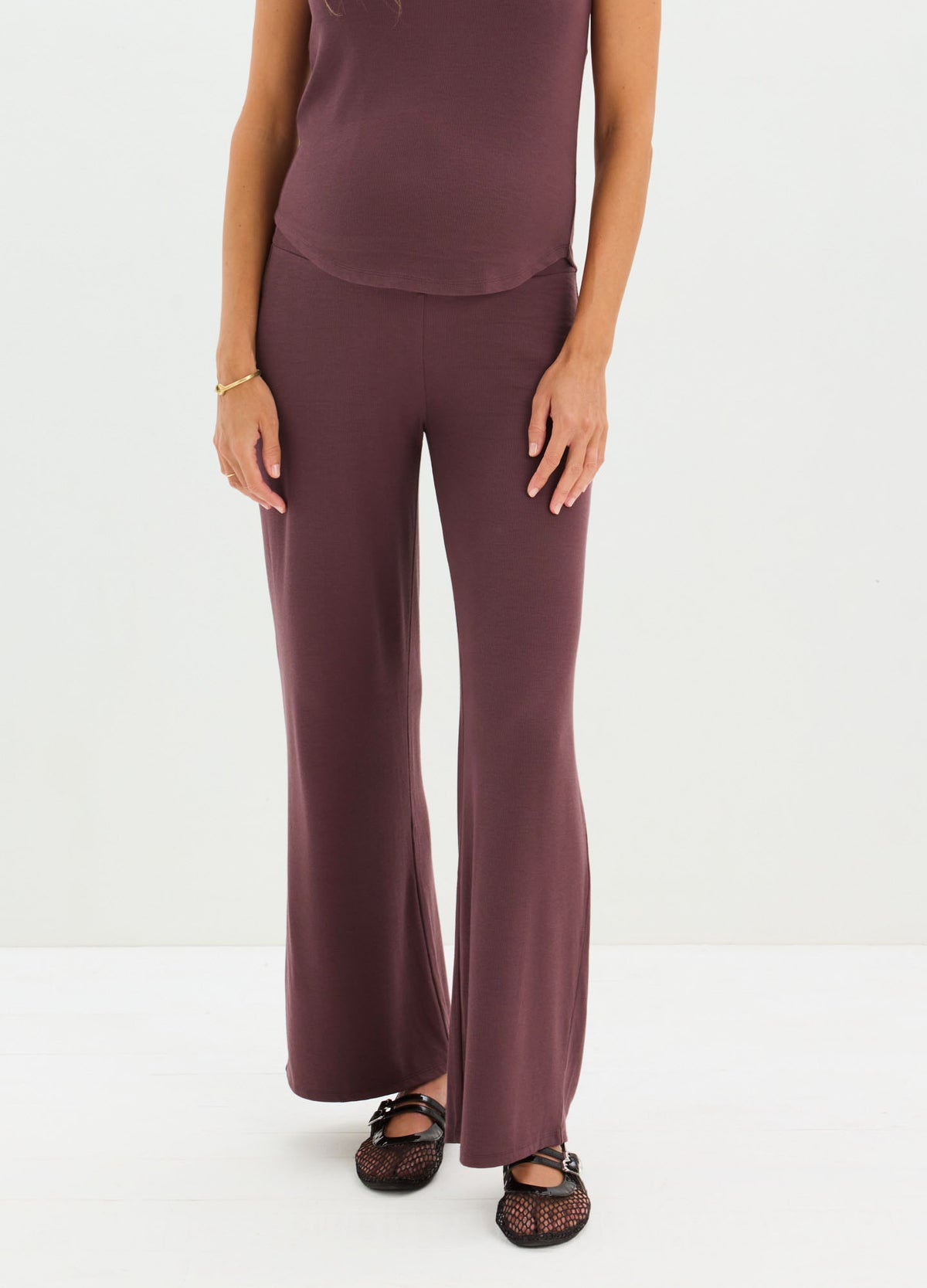 Maternity relaxed-fit ribbed pants in deep plum with wide legs and high waistband.