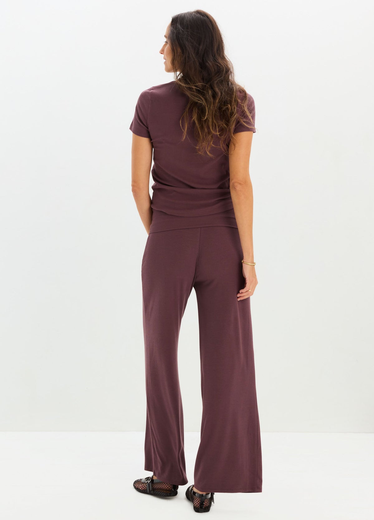 Maternity soft ribbed knit pants in deep mauve with relaxed wide legs and an elastic waistband.