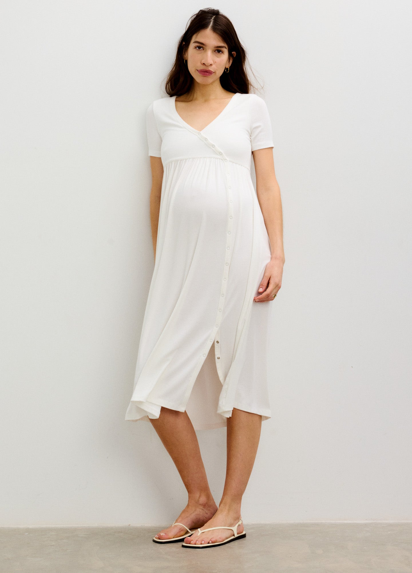 White ribbed knit nursing maxi dress with short sleeves and side seam slits, designed for maternity and postpartum comfort.