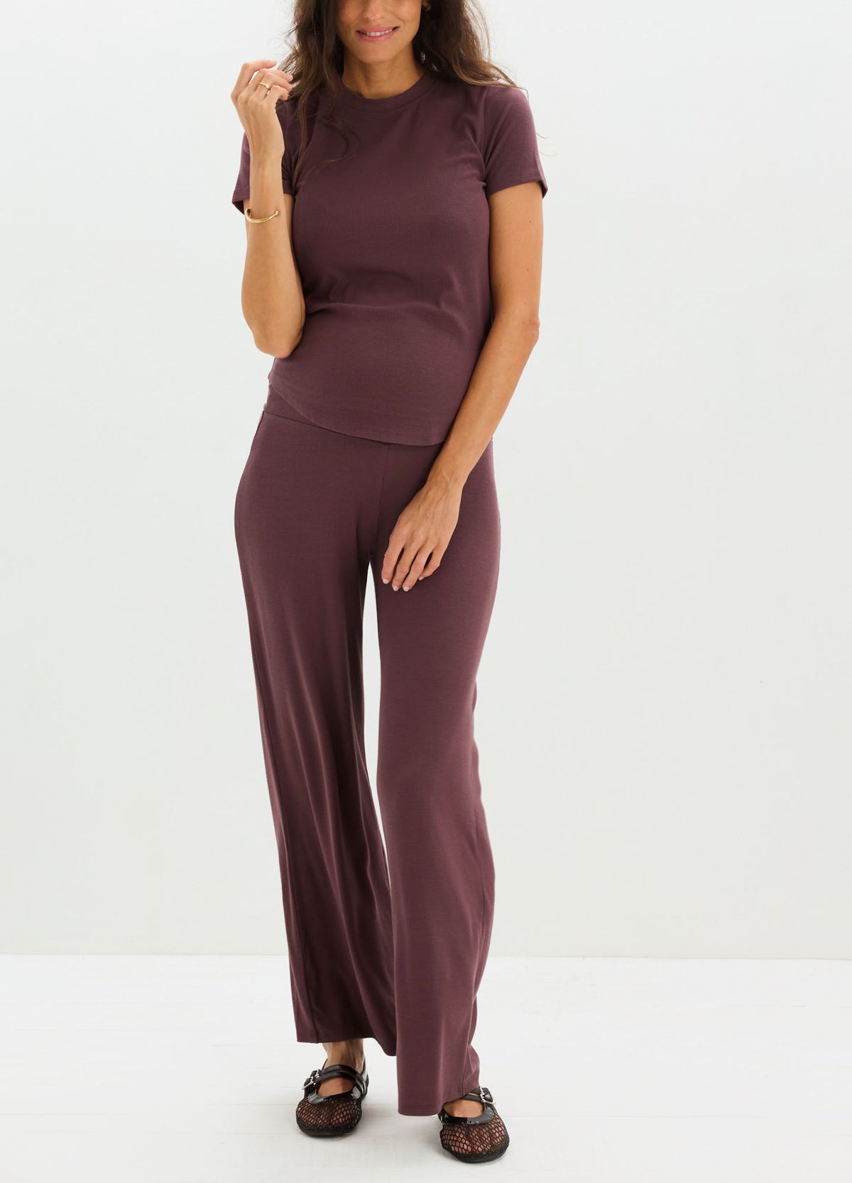 Soft ribbed maternity tee in deep plum with short sleeves and a fitted silhouette.