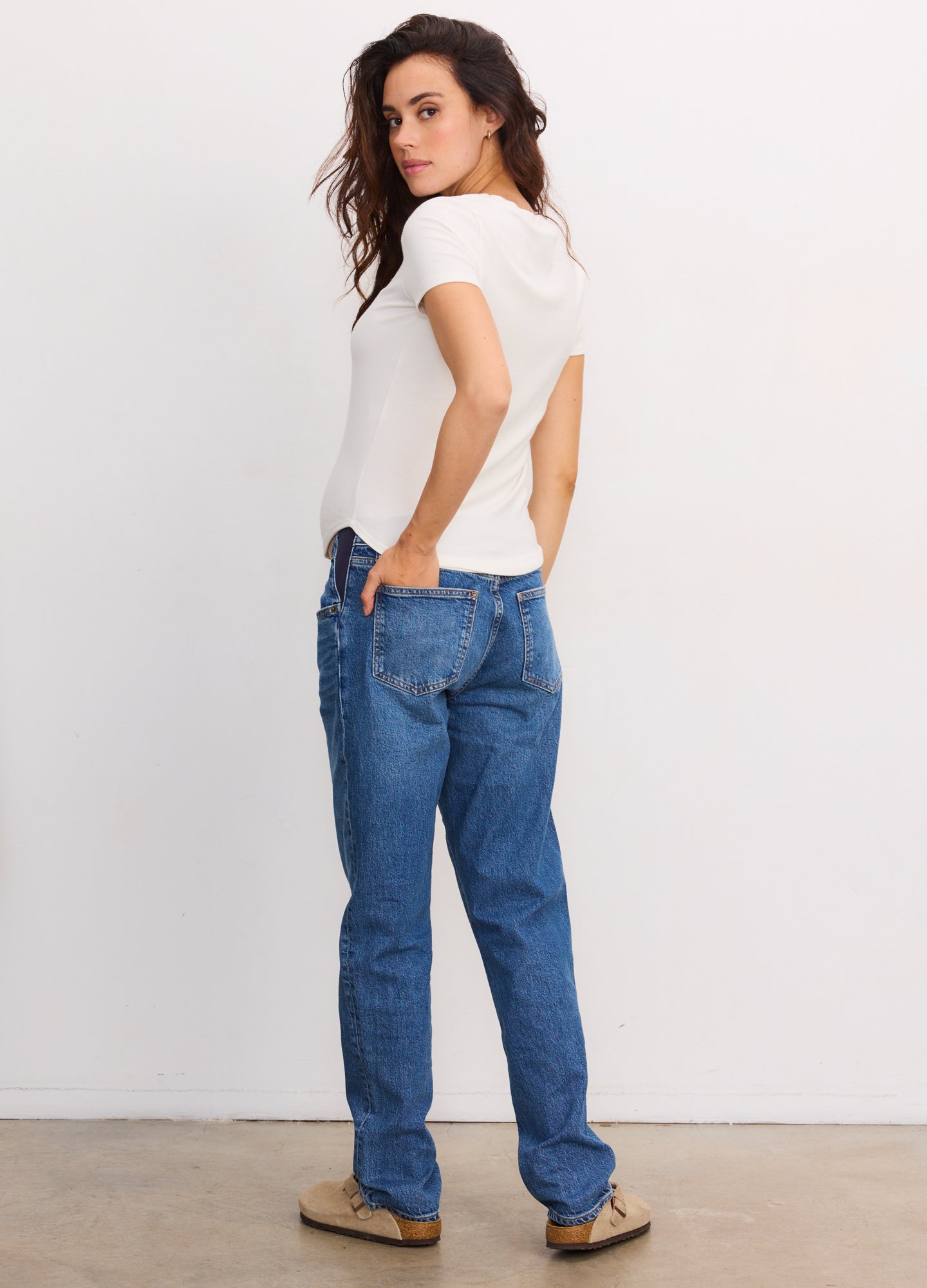 White short-sleeve ribbed maternity tee with fitted silhouette on pregnant model.