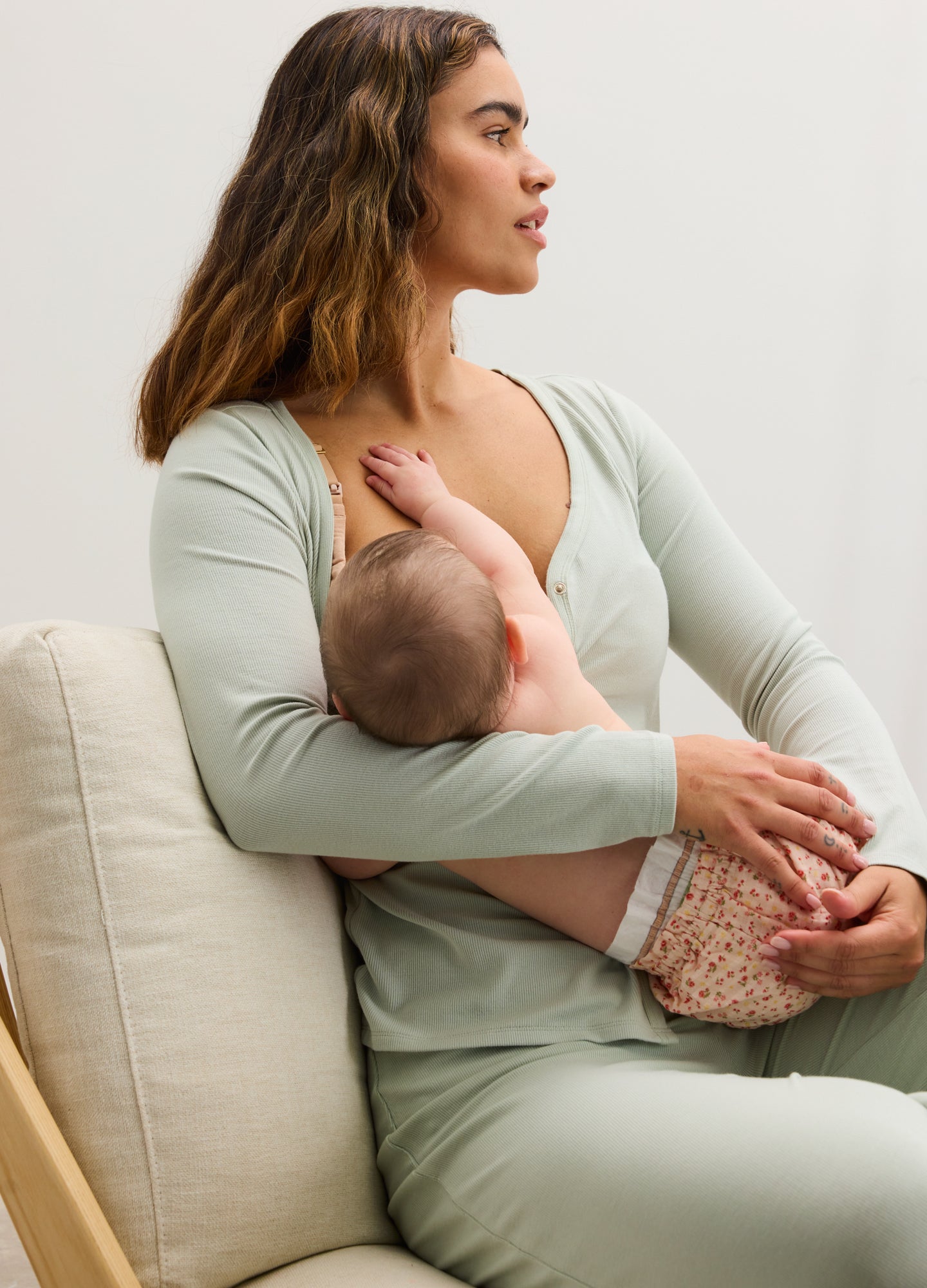 Light sage green ribbed nursing cardigan with long sleeves, worn open for easy breastfeeding access.