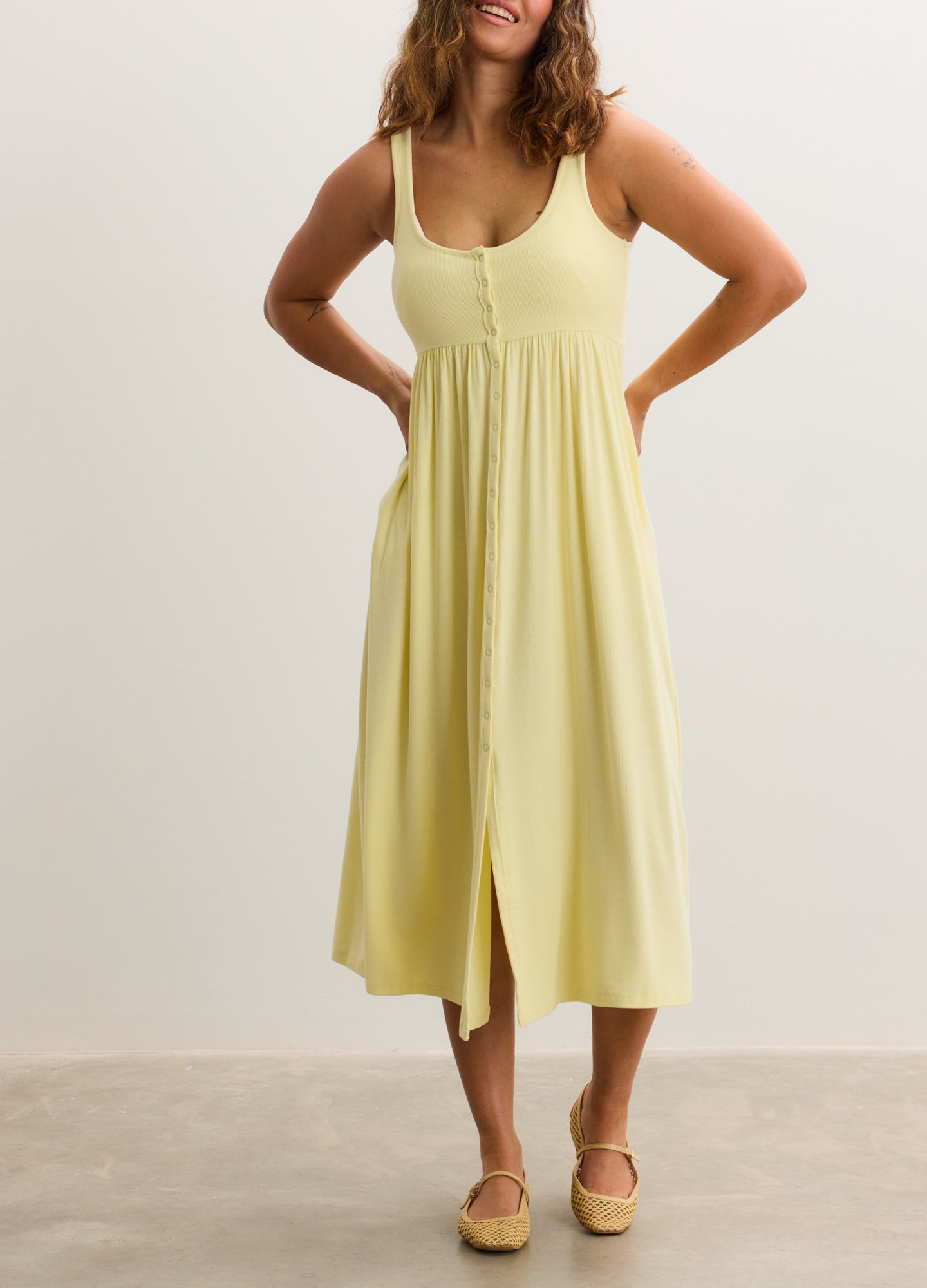 Light yellow ribbed maternity nursing tank dress with scoop neck and front button detail.