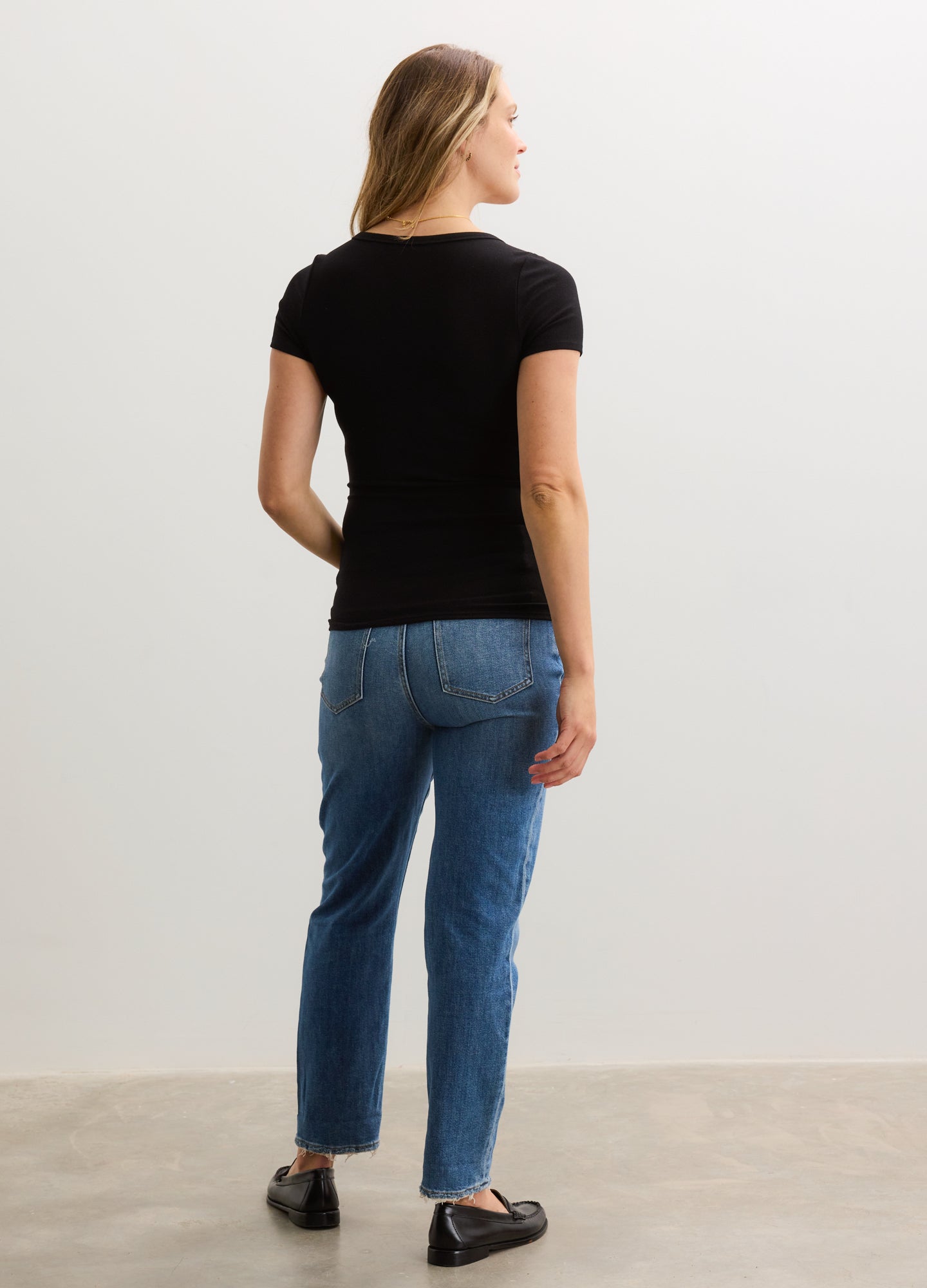 Black ribbed short-sleeve nursing tee with a fitted silhouette on a pregnant model.