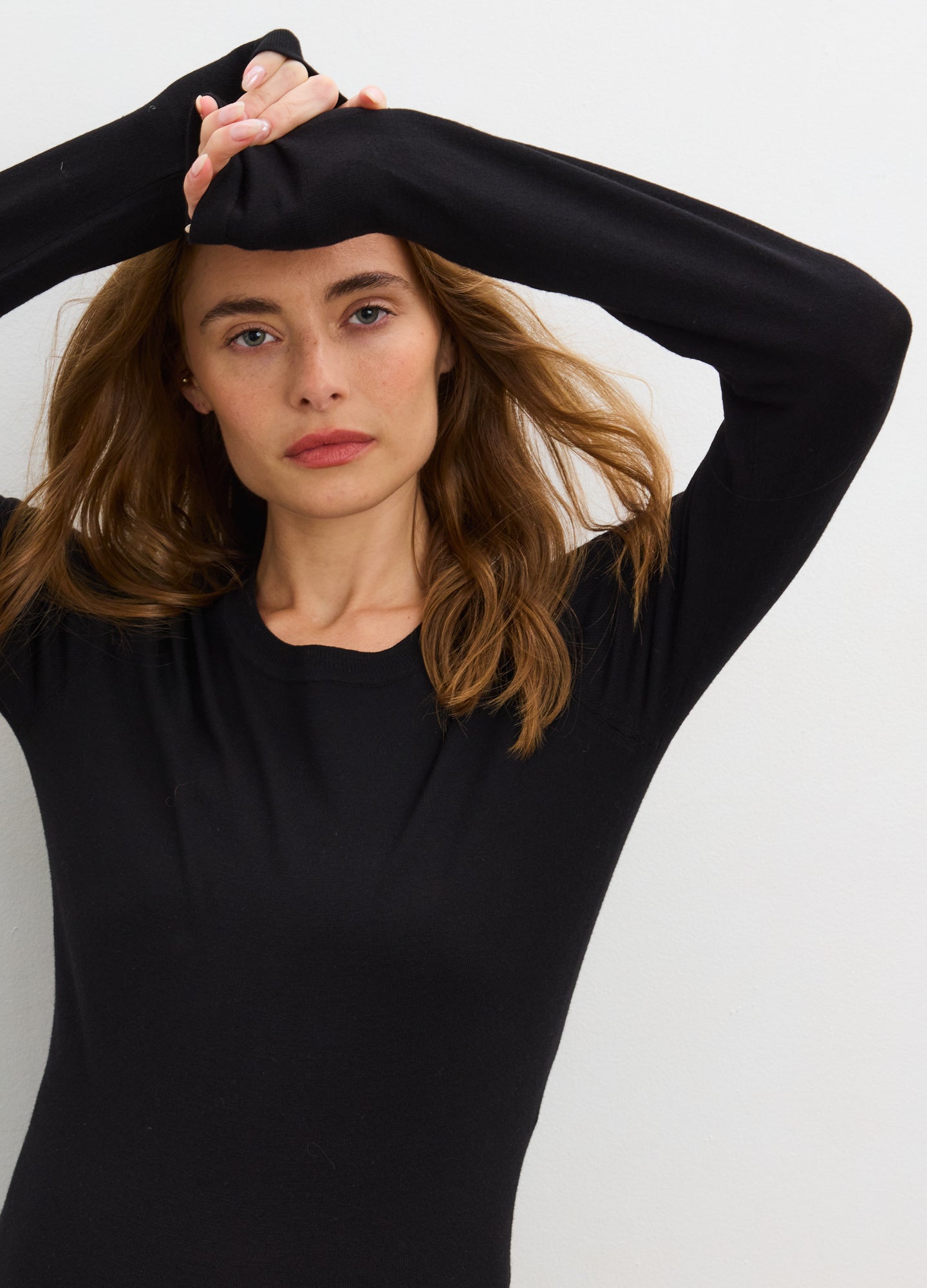 Black knit long sleeve maternity tee with soft stretch fabric, designed for pregnant bodies.