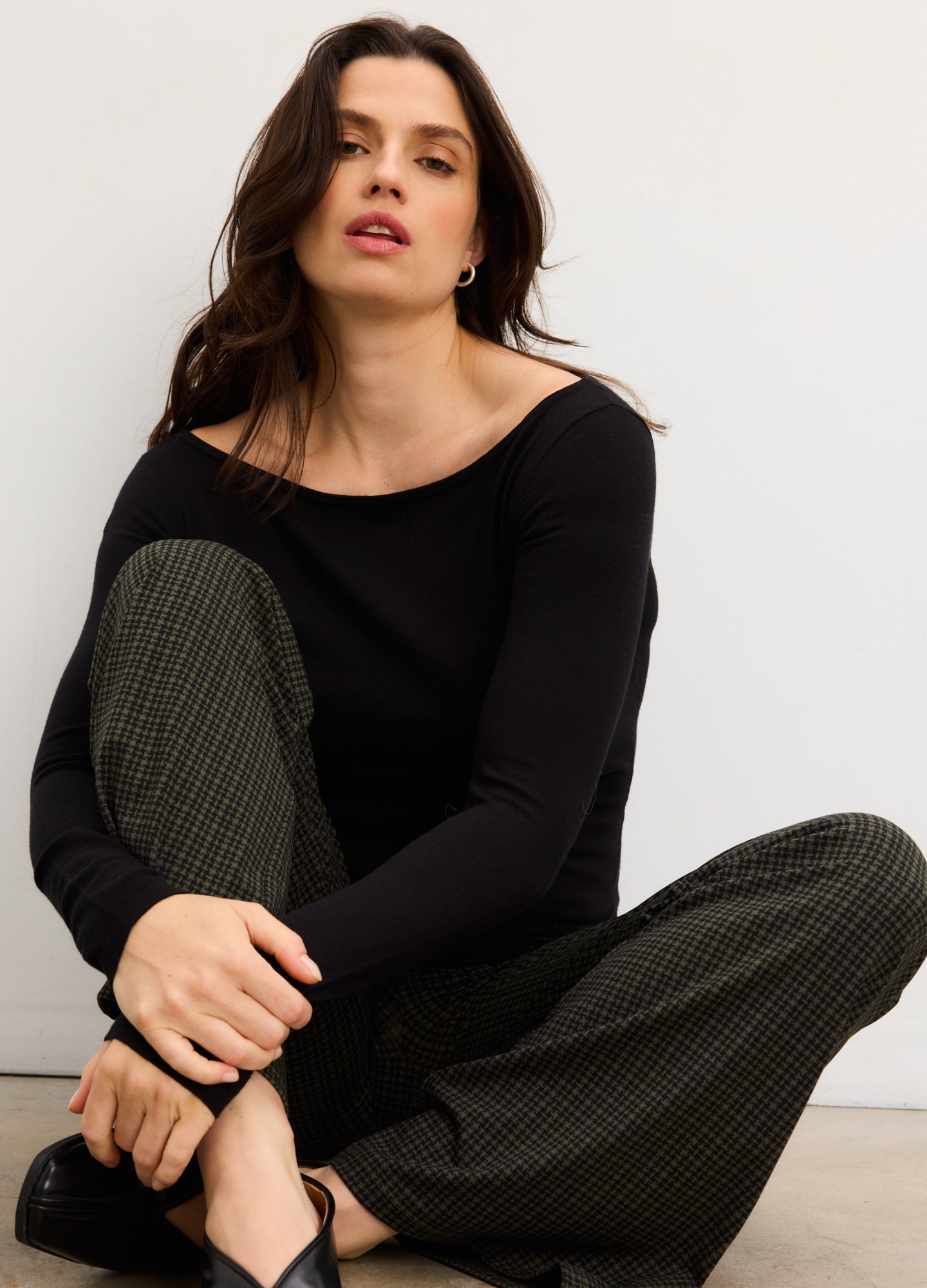 Black long-sleeve maternity top with off-shoulder neckline, worn by pregnant model.