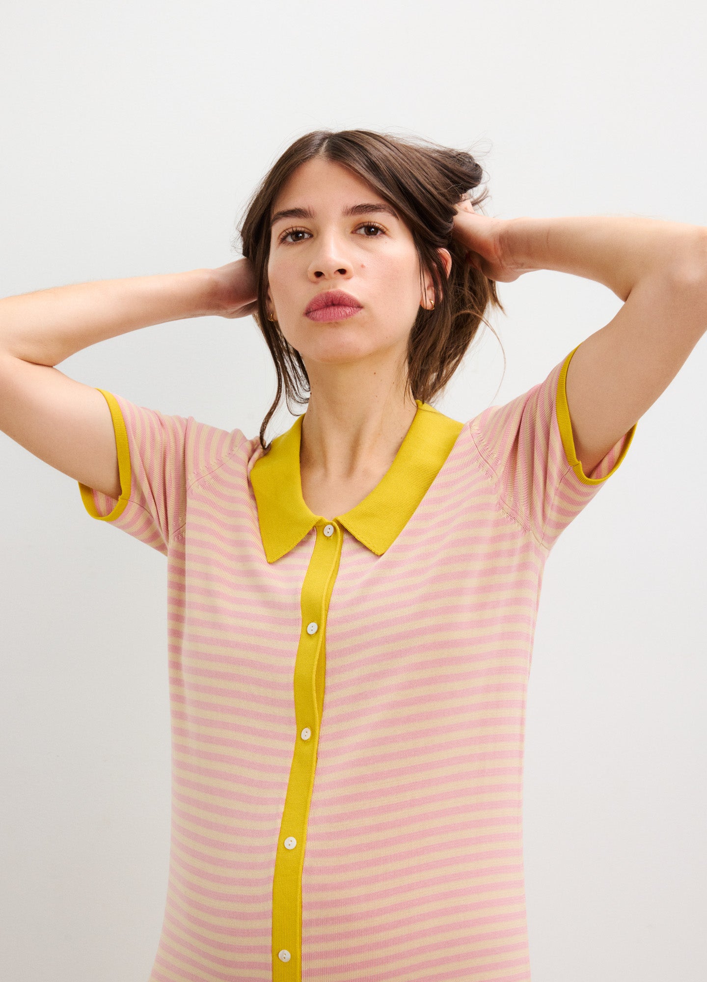 Pink and white striped maternity dress with short sleeves, yellow collar, and button-down front.