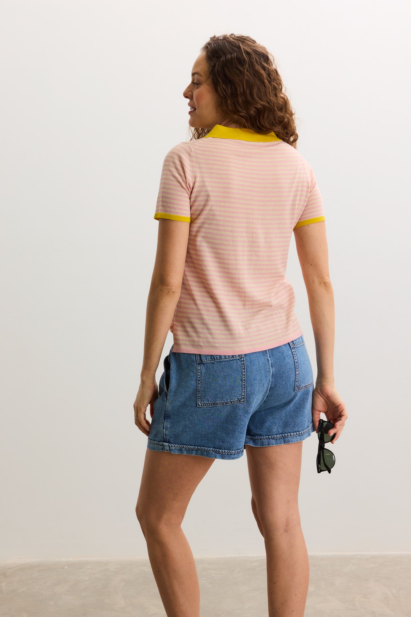 Pink maternity shirt with yellow collar and sleeve cuffs, short sleeves, fitted silhouette.