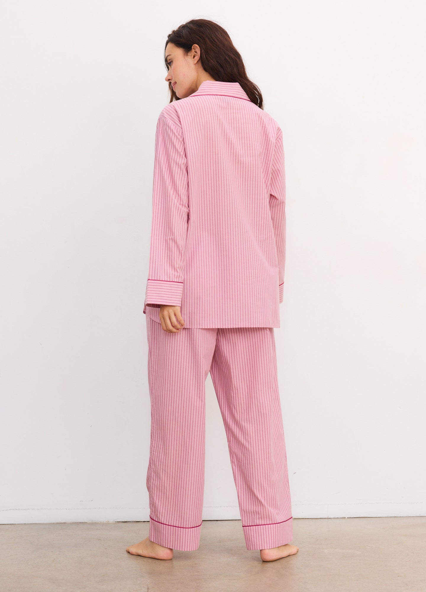 Soft pink cotton maternity pajama set with long sleeves and relaxed straight-leg pants, back view.