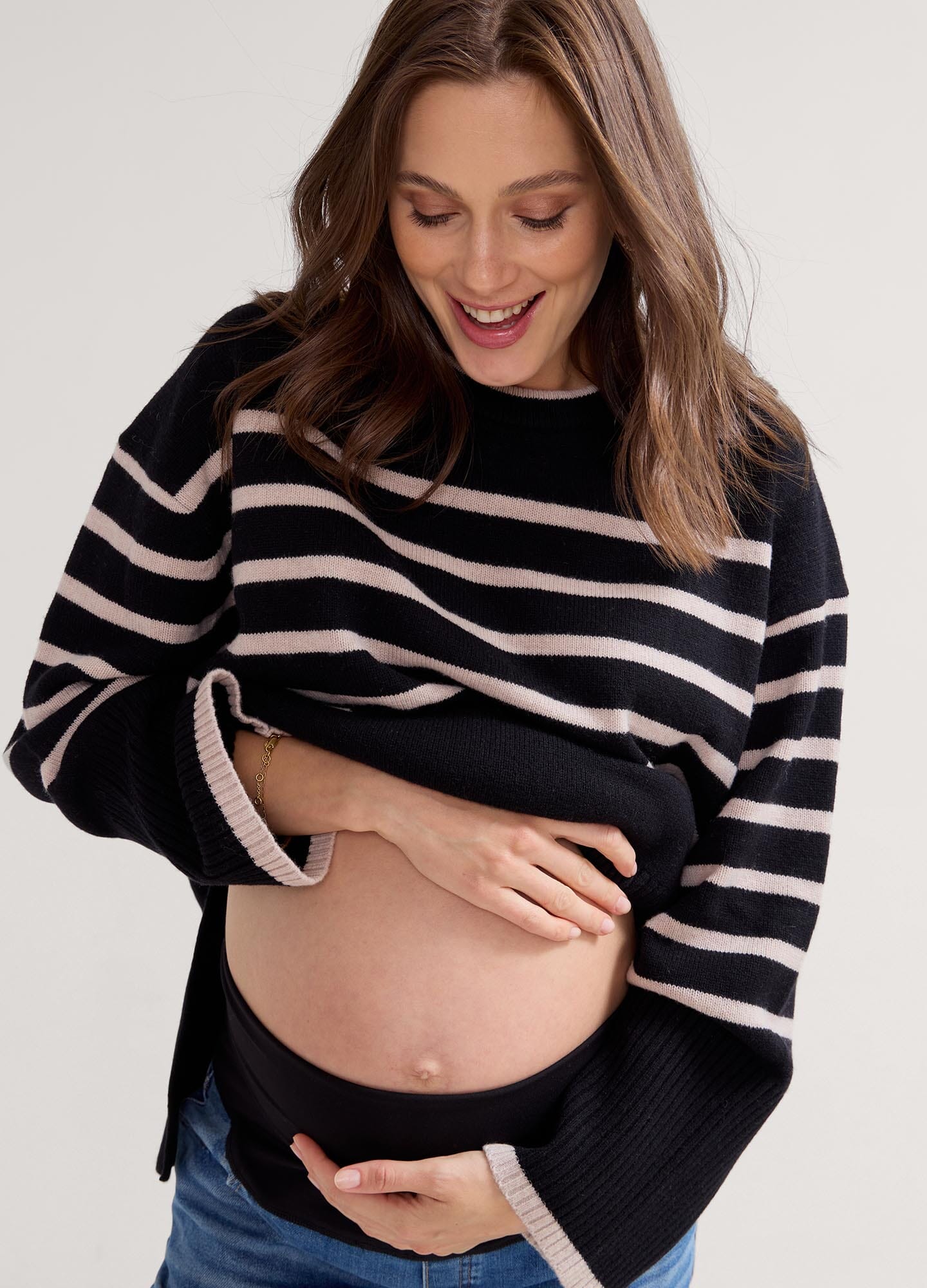 The Carly Knit Pullover - Black and oat melange striped knit pullover with side slits, designed for maternity, nursing, and postpartum comfort.