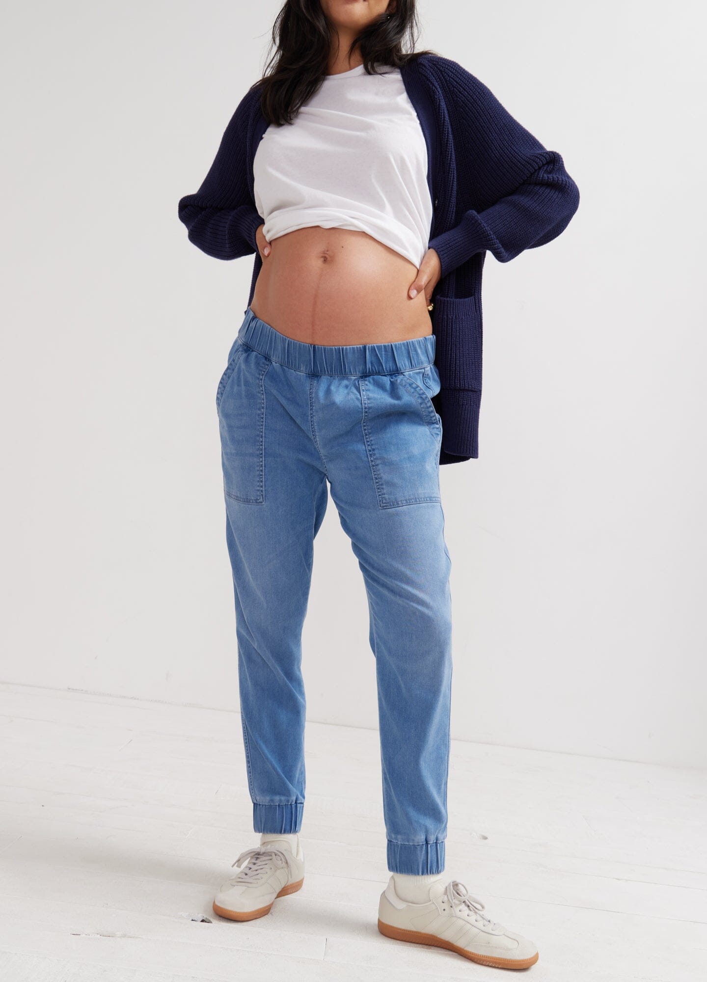The Easy Denim Jogger - Faded indigo maternity denim joggers with elastic waistband, styled for pregnancy and postpartum comfort.
