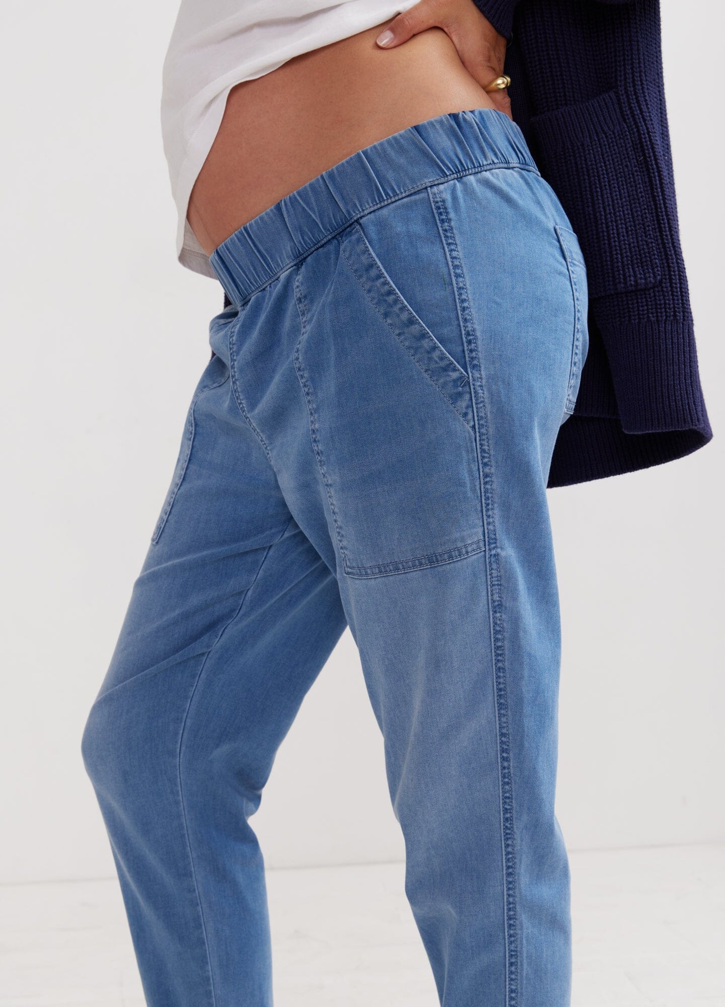 The Easy Denim Jogger - Faded indigo maternity denim joggers with elastic waistband, styled for pregnancy and postpartum comfort.