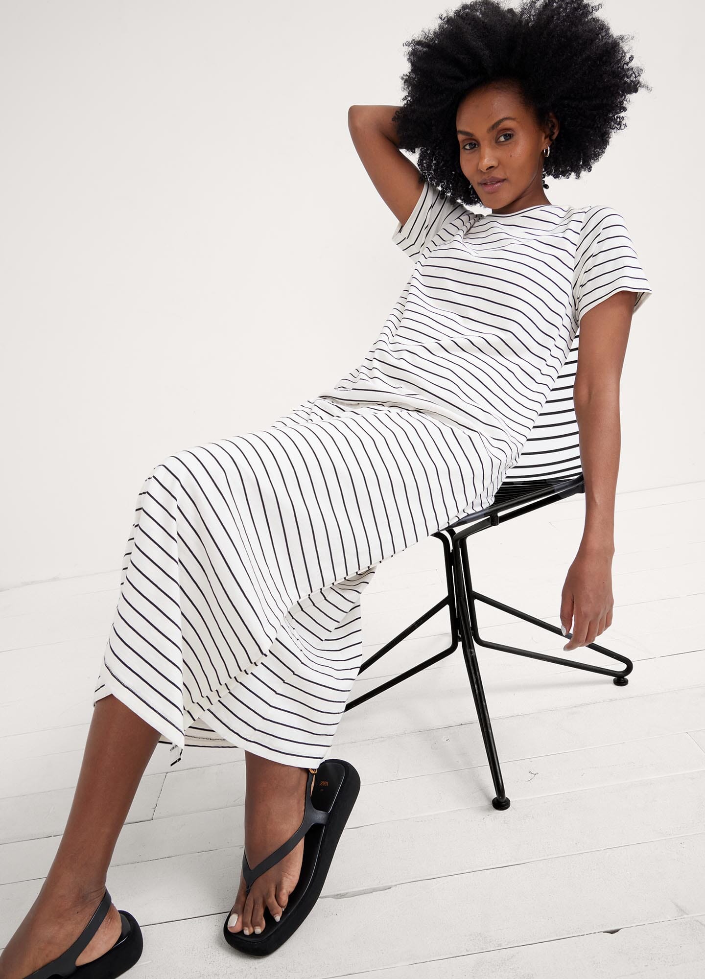 The Easy Going Nursing Tee Dress - Black and white striped nursing tee dress with short sleeves, designed for maternity, pregnancy, and postpartum comfort.