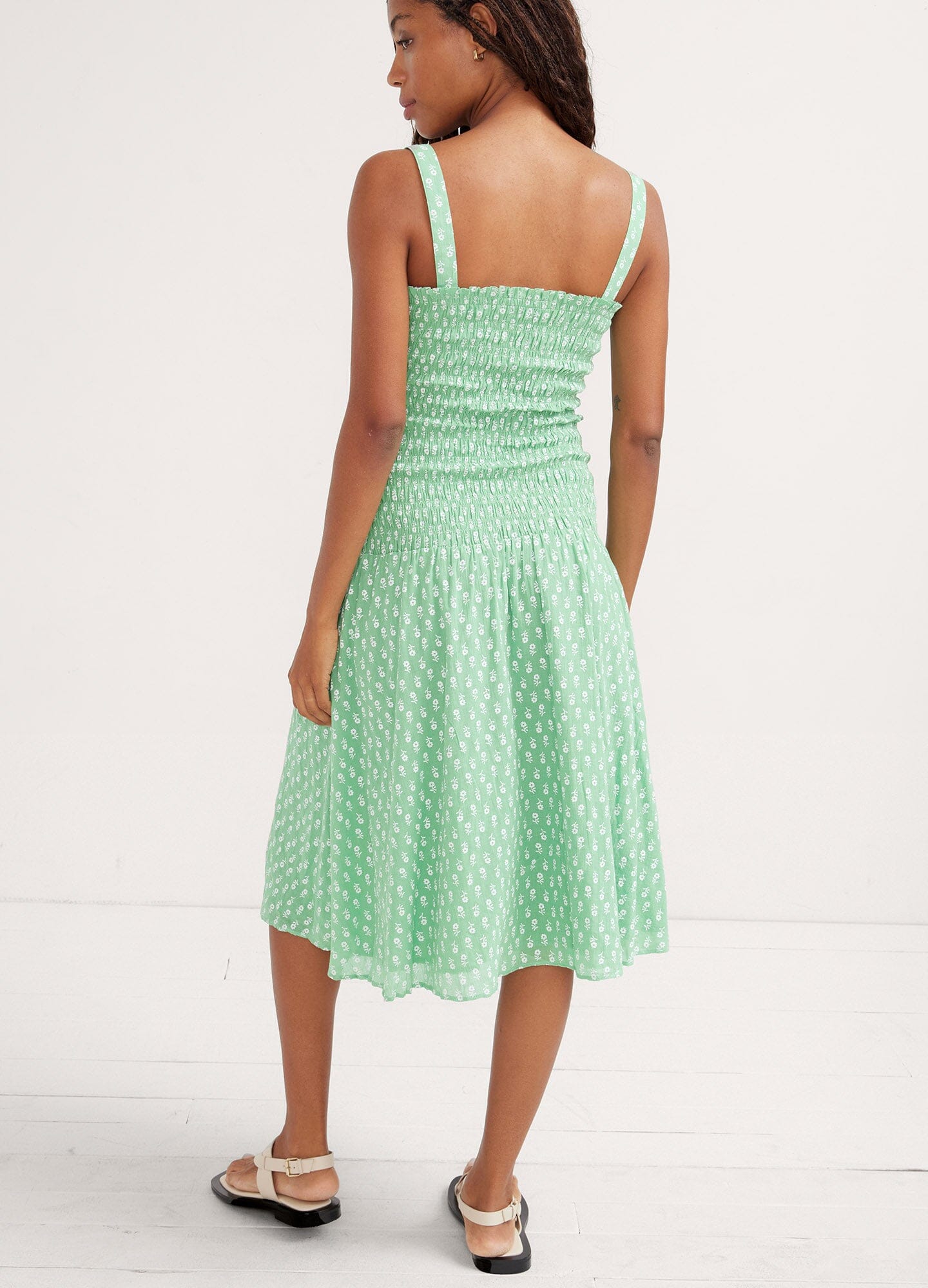 The Evie Dress - Green ditsy batik maternity dress with adjustable straps and smocked bust for pregnancy, nursing, and postpartum comfort.