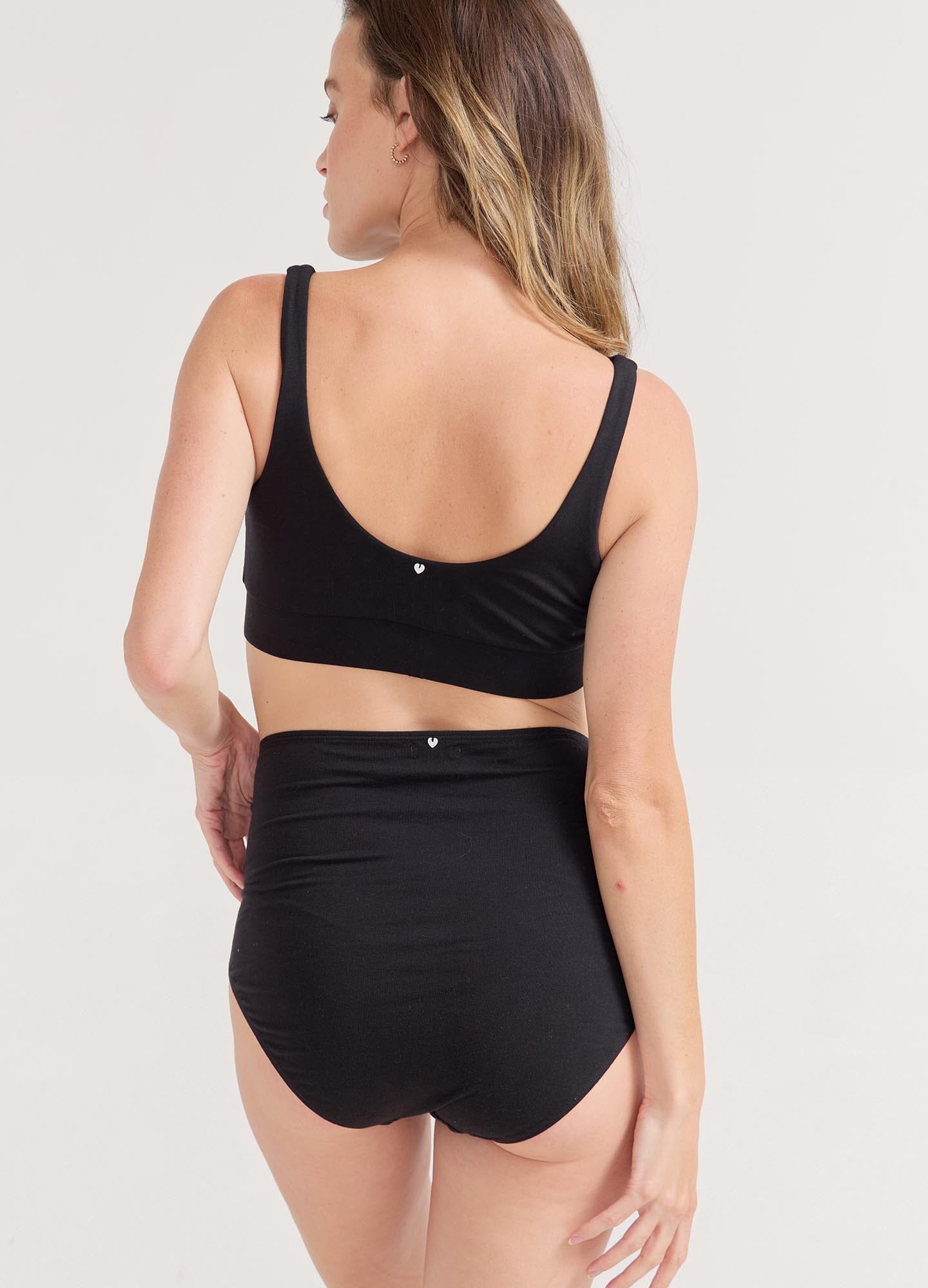 The High Tuck Brief POS - Navy rosette maternity high tuck briefs with full coverage, modeled for pregnancy and postpartum comfort.