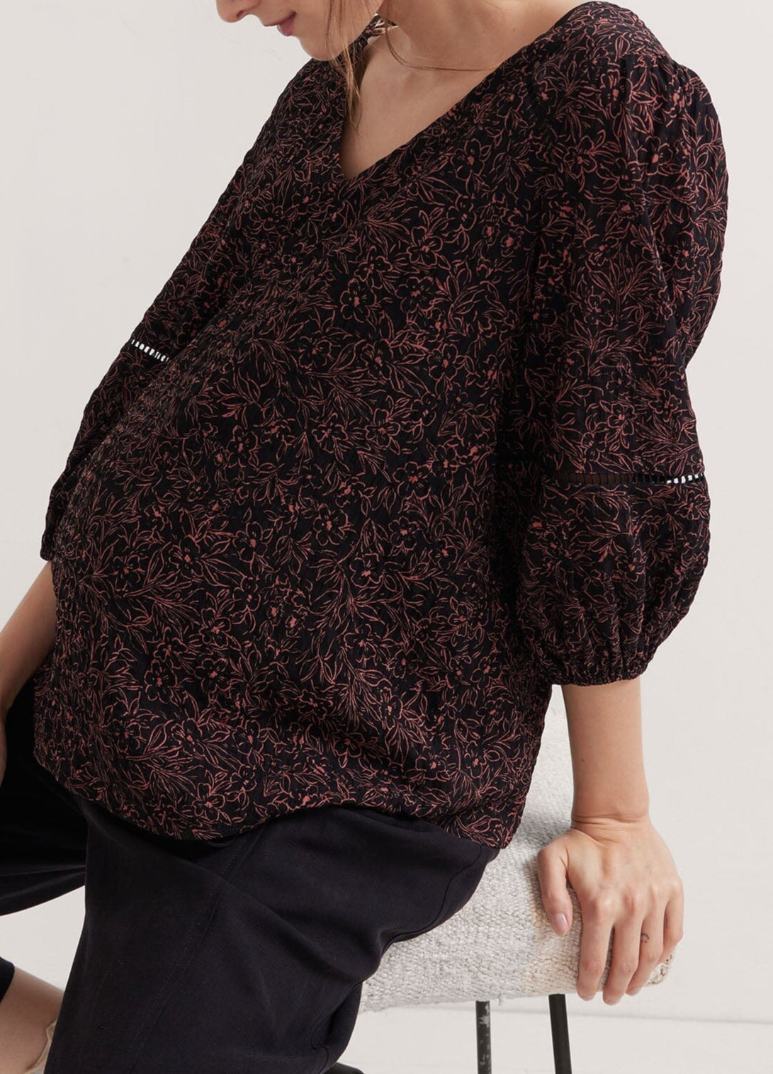 The Juliet Top - Black and pink floral maternity nursing top with V-neck and 3/4 puff sleeves, ruched sides for postpartum comfort.