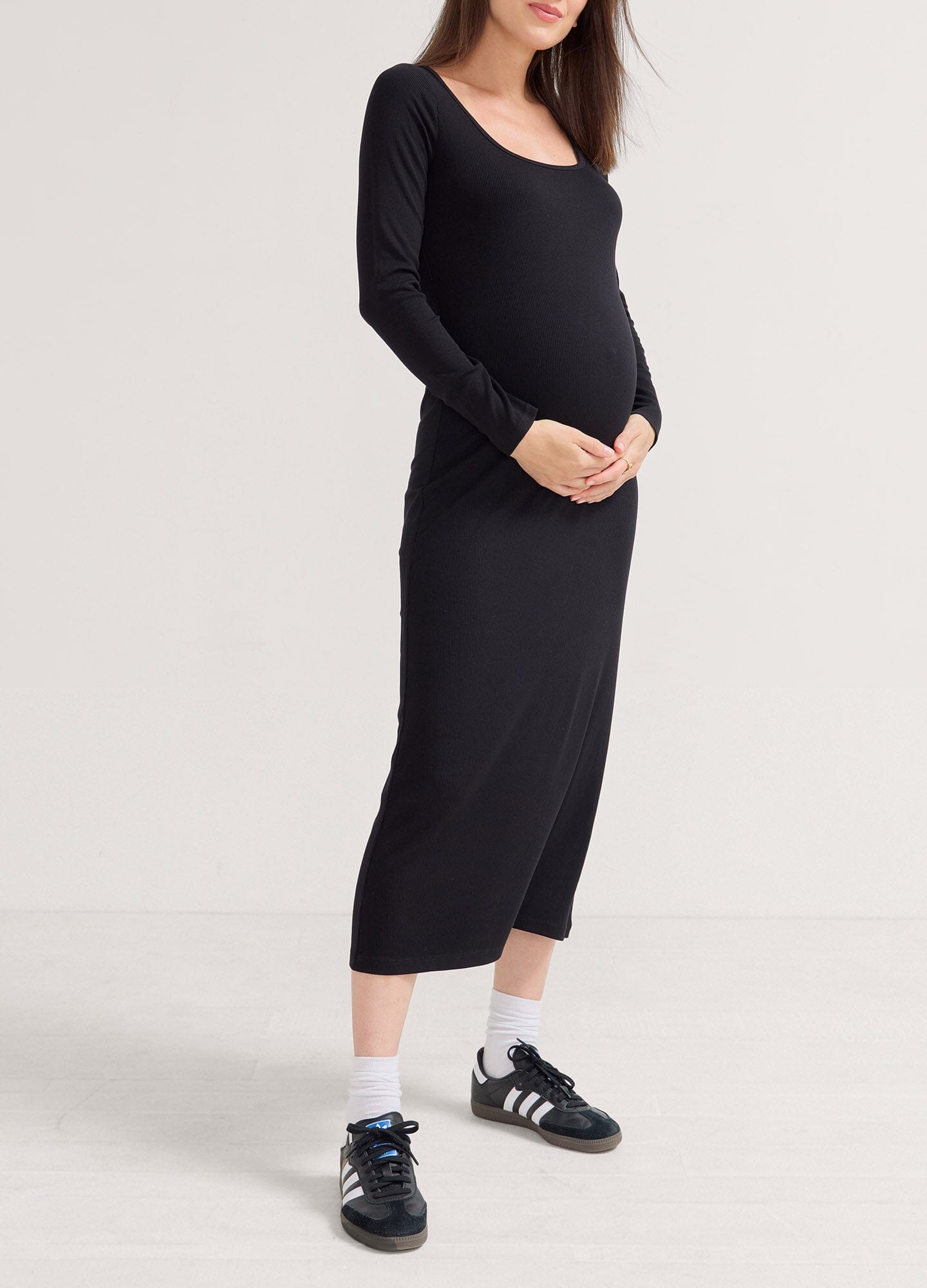 The Longsleeve Rib Dress - Black long sleeve ribbed maternity dress with fitted silhouette, designed for pregnancy, nursing, and postpartum wear.
