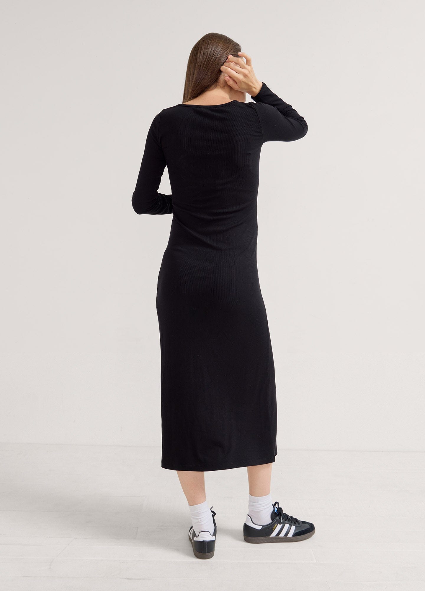 The Longsleeve Rib Dress - Black long sleeve ribbed maternity dress with fitted silhouette, designed for pregnancy, nursing, and postpartum wear.
