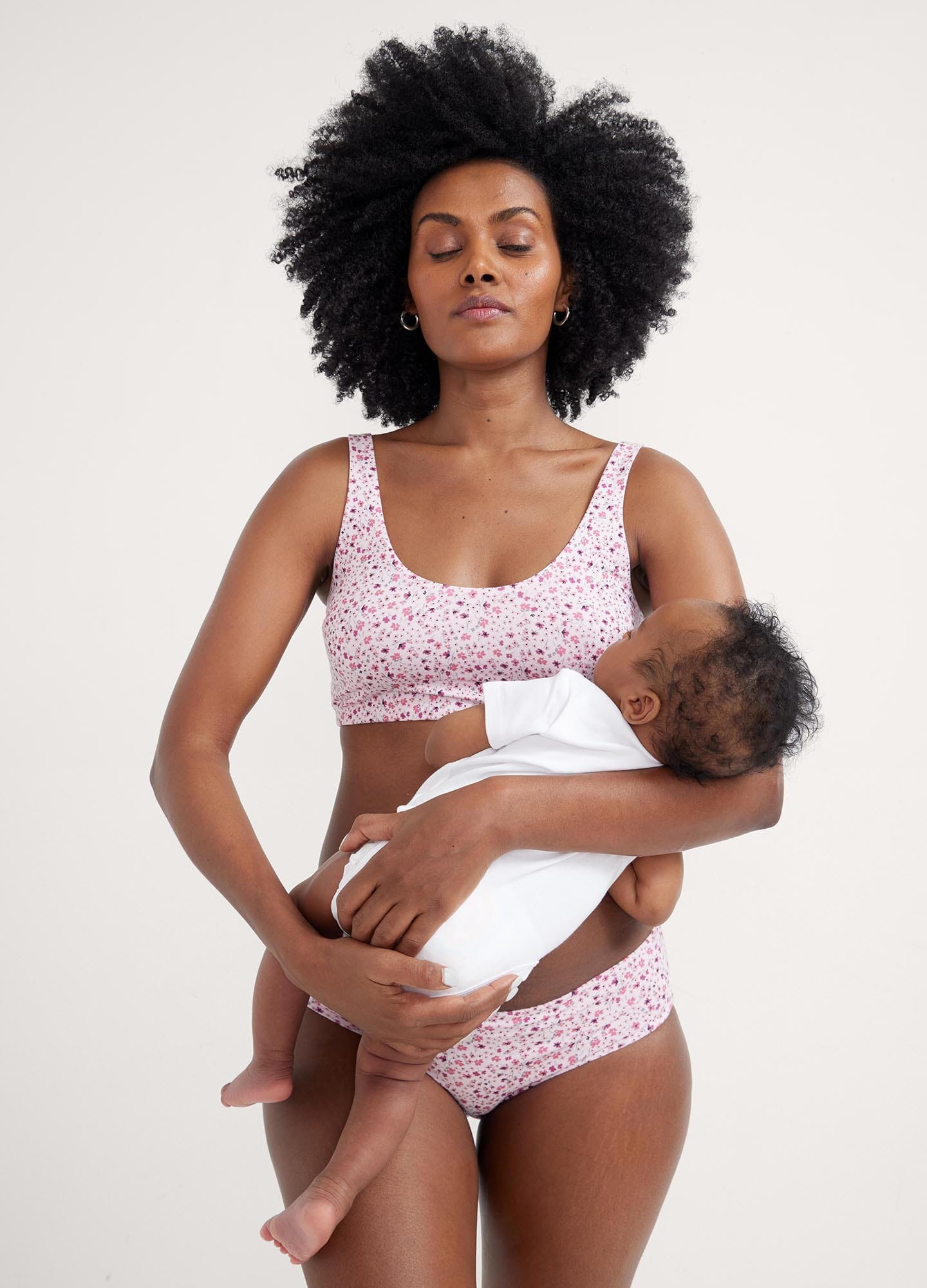 The Skin To Skin Bra - Soft pink ditsy wildflower maternity nursing bra with wide straps and seamless cups for postpartum comfort.