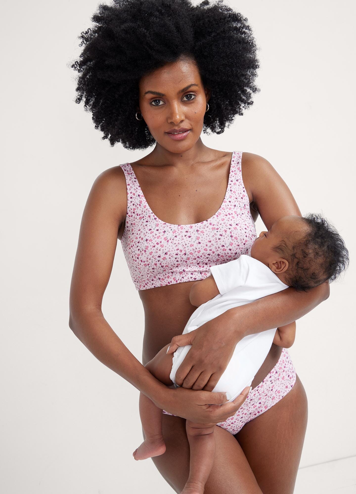 The Skin To Skin Bra - Soft pink ditsy wildflower maternity nursing bra with wide straps and seamless cups for postpartum comfort.