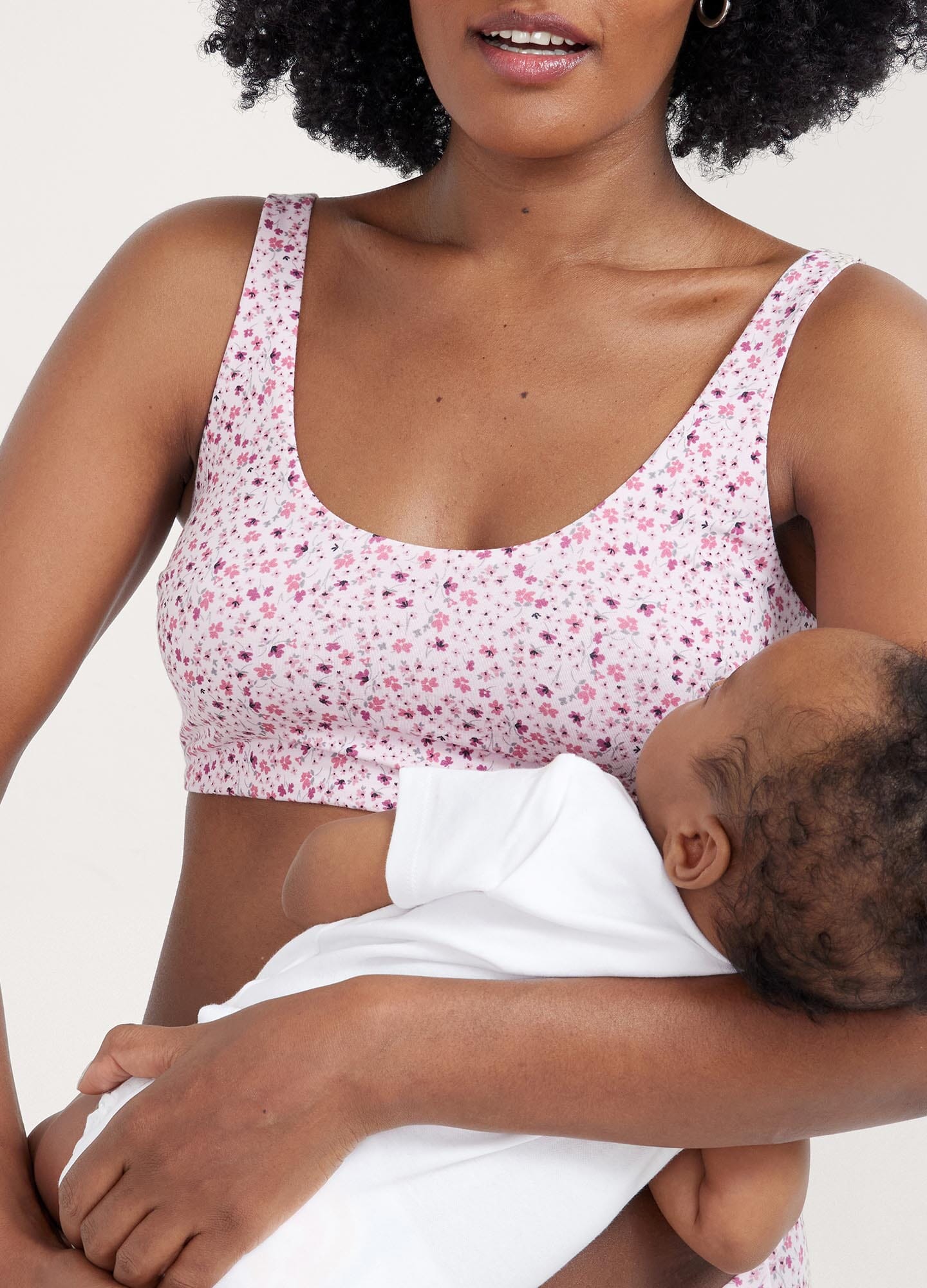 The Skin To Skin Bra - Soft pink ditsy wildflower maternity nursing bra with wide straps and seamless cups for postpartum comfort.