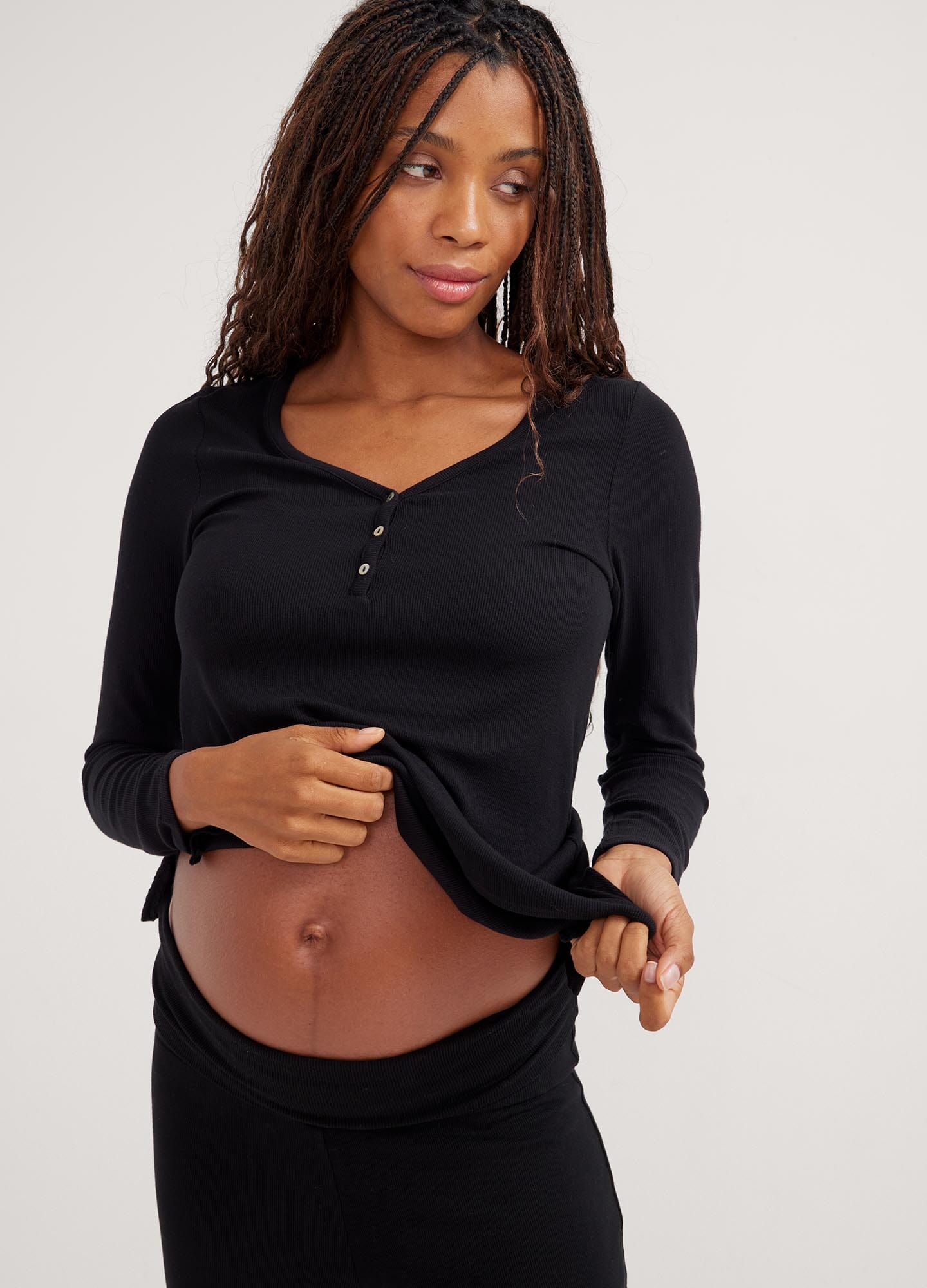 The Softest Rib Relaxed Nursing Henley - Black ribbed nursing henley with long sleeves and buttoned placket, designed for maternity and postpartum comfort.