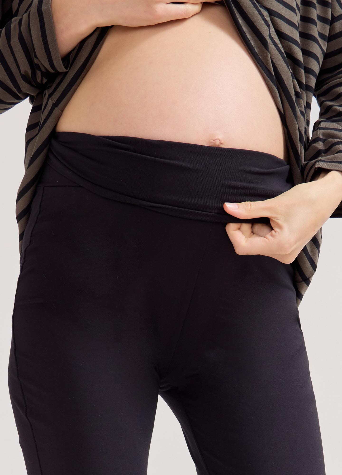 The Ultimate Before, During & After Crop Flare - Black maternity flare pants with side slits, designed for pregnancy, nursing, and postpartum.